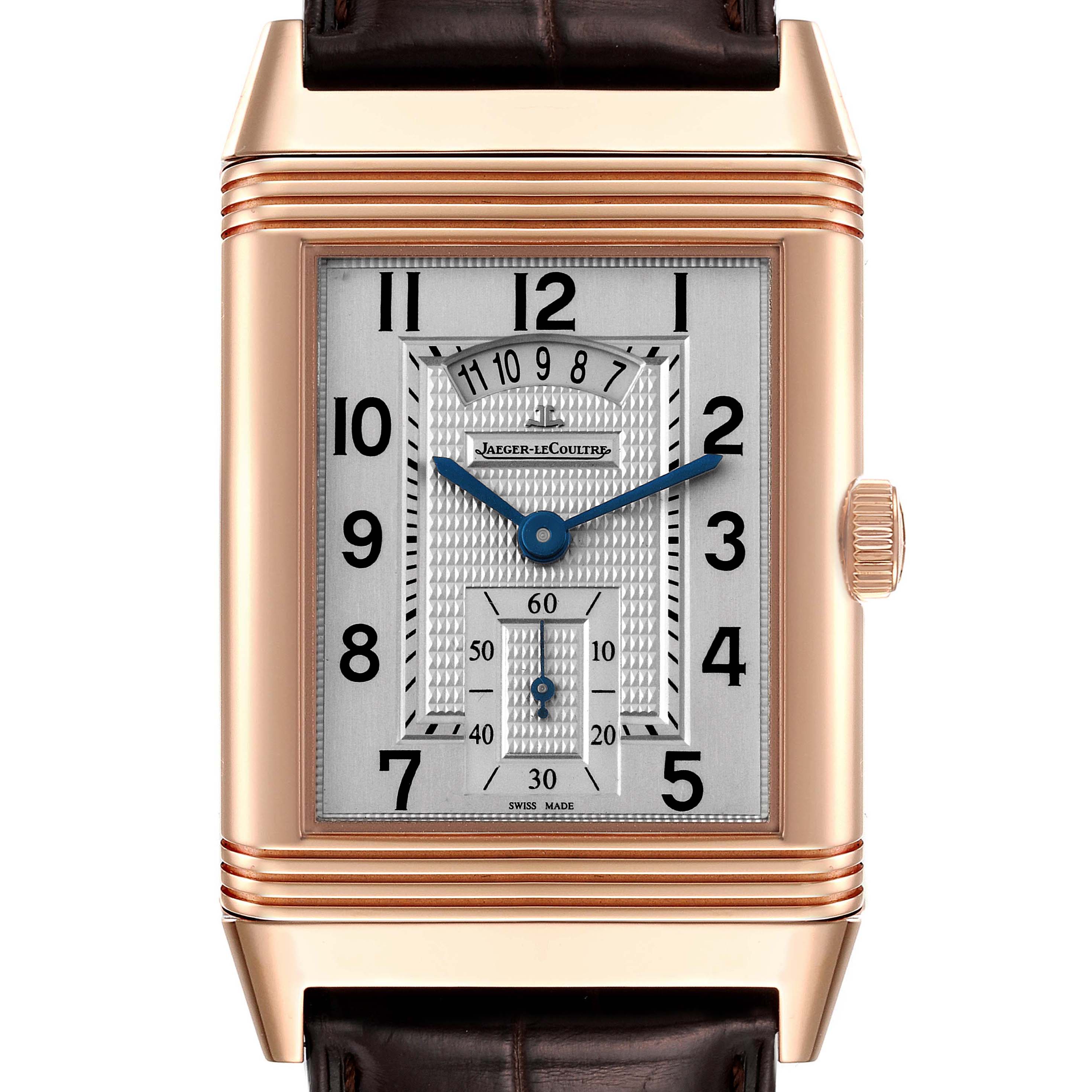 The image shows a front view of the Reverso watch by Jaeger LeCoultre, highlighting the rectangular case, dial, hands, and crown.