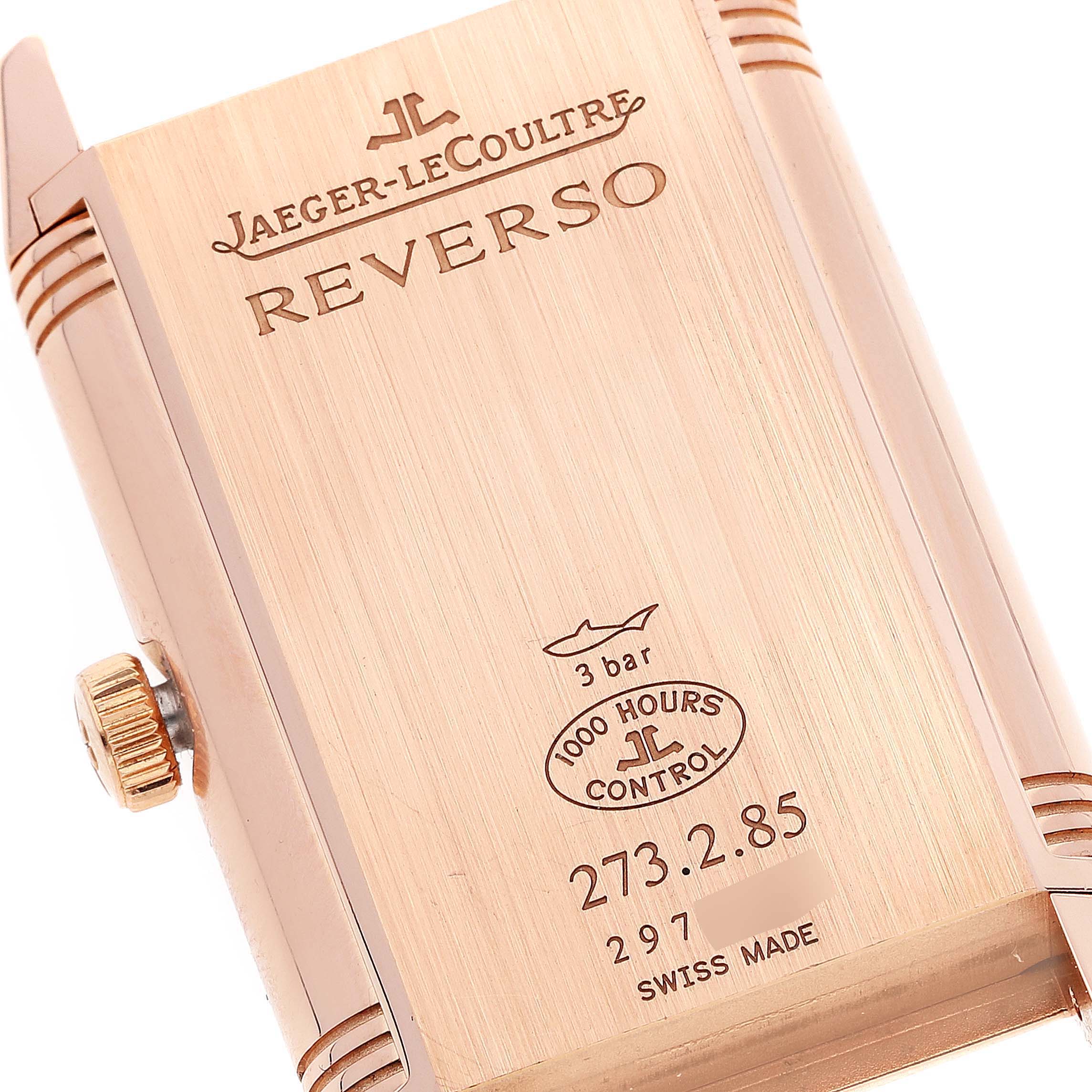 This image shows the back of a Jaeger-LeCoultre Reverso watch, highlighting the case, crown, and engravings.