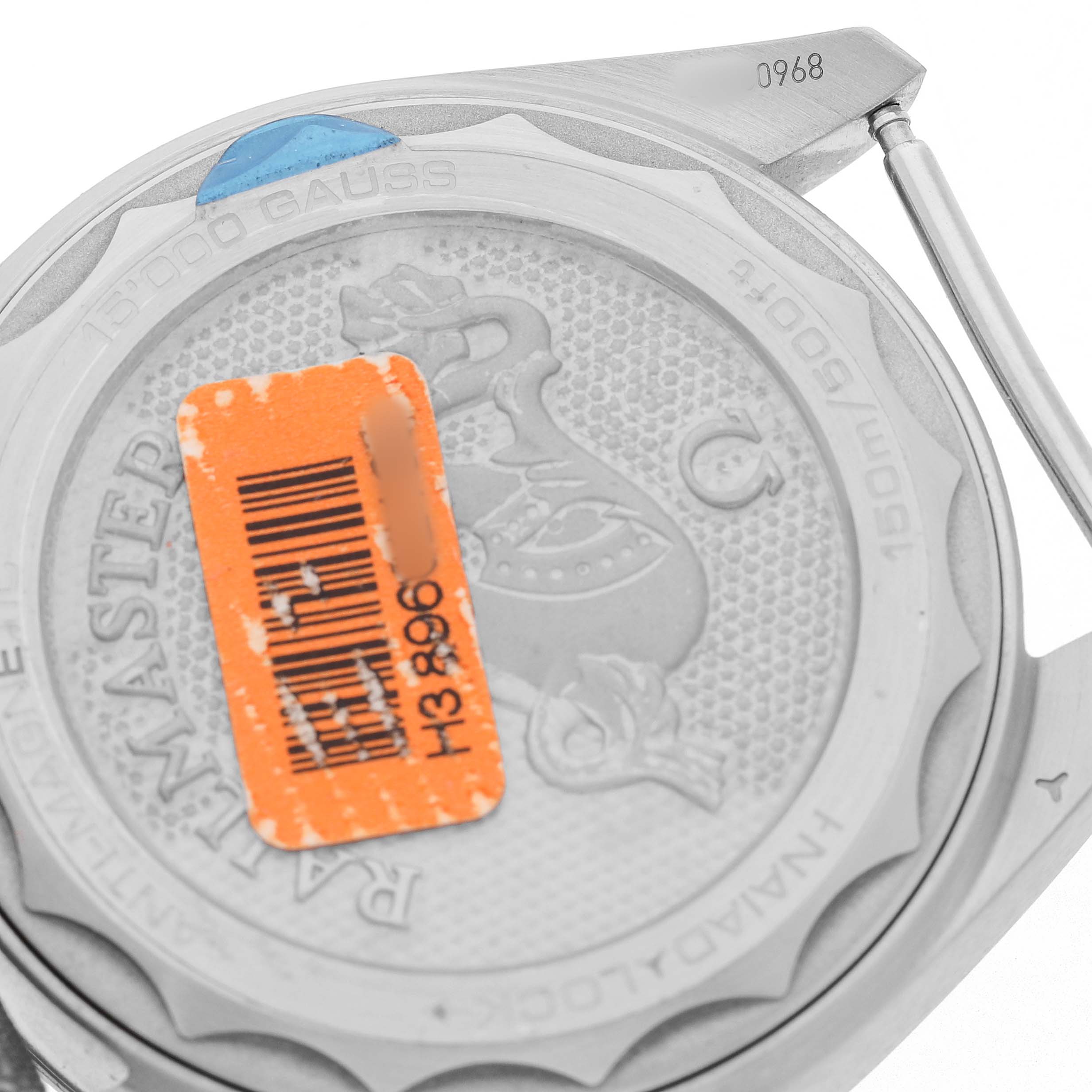 The image shows the back case of an Omega Seamaster 220.12.40.20.06.001 Men's Stainless Steel Grey Dial watch, highlighting the engraved details and an orange sticker.