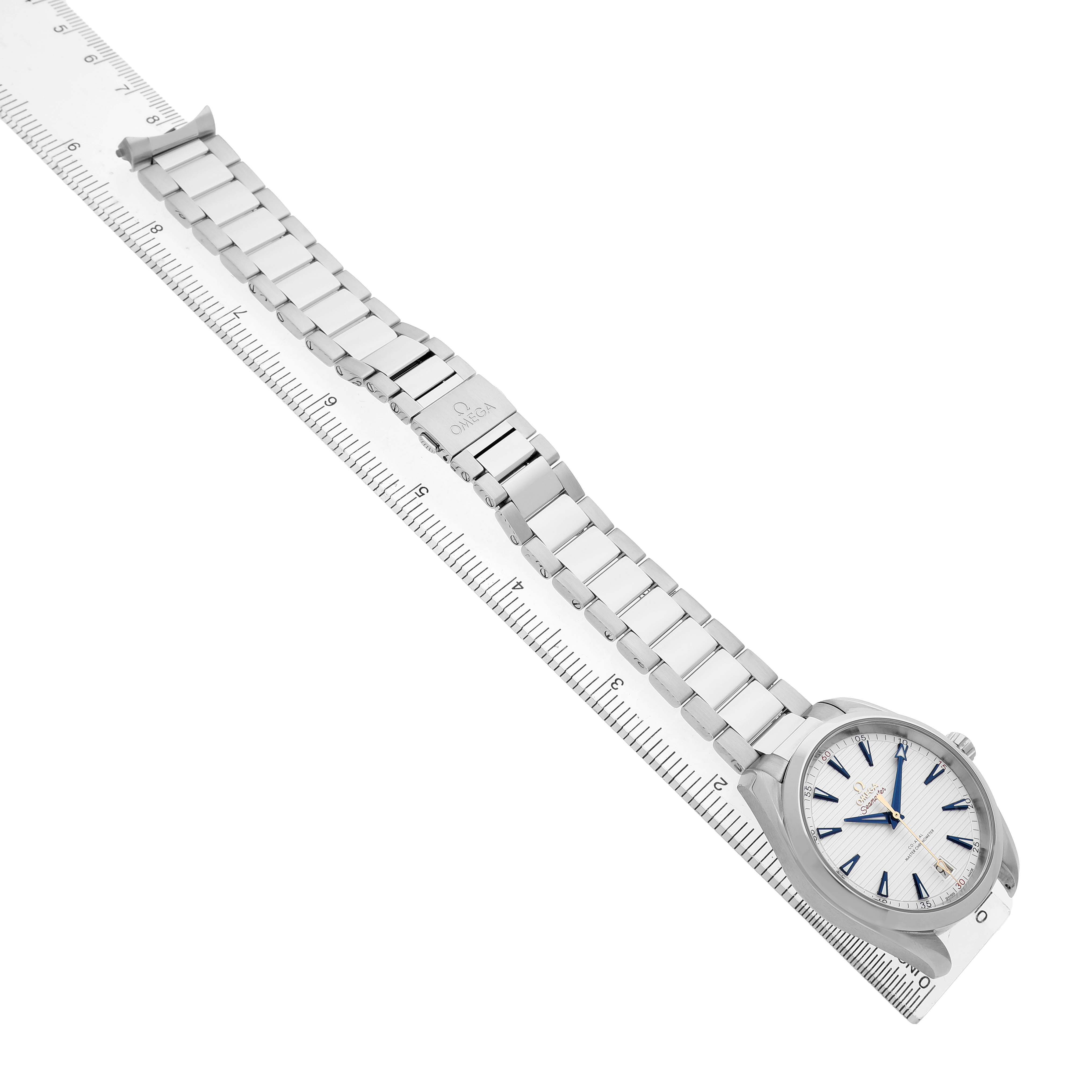 The Omega Seamaster 220.12.41.21.02.004 Men's Stainless Steel Silver Dial watch is shown at a diagonal angle, displaying the face and full metal bracelet alongside a ruler.