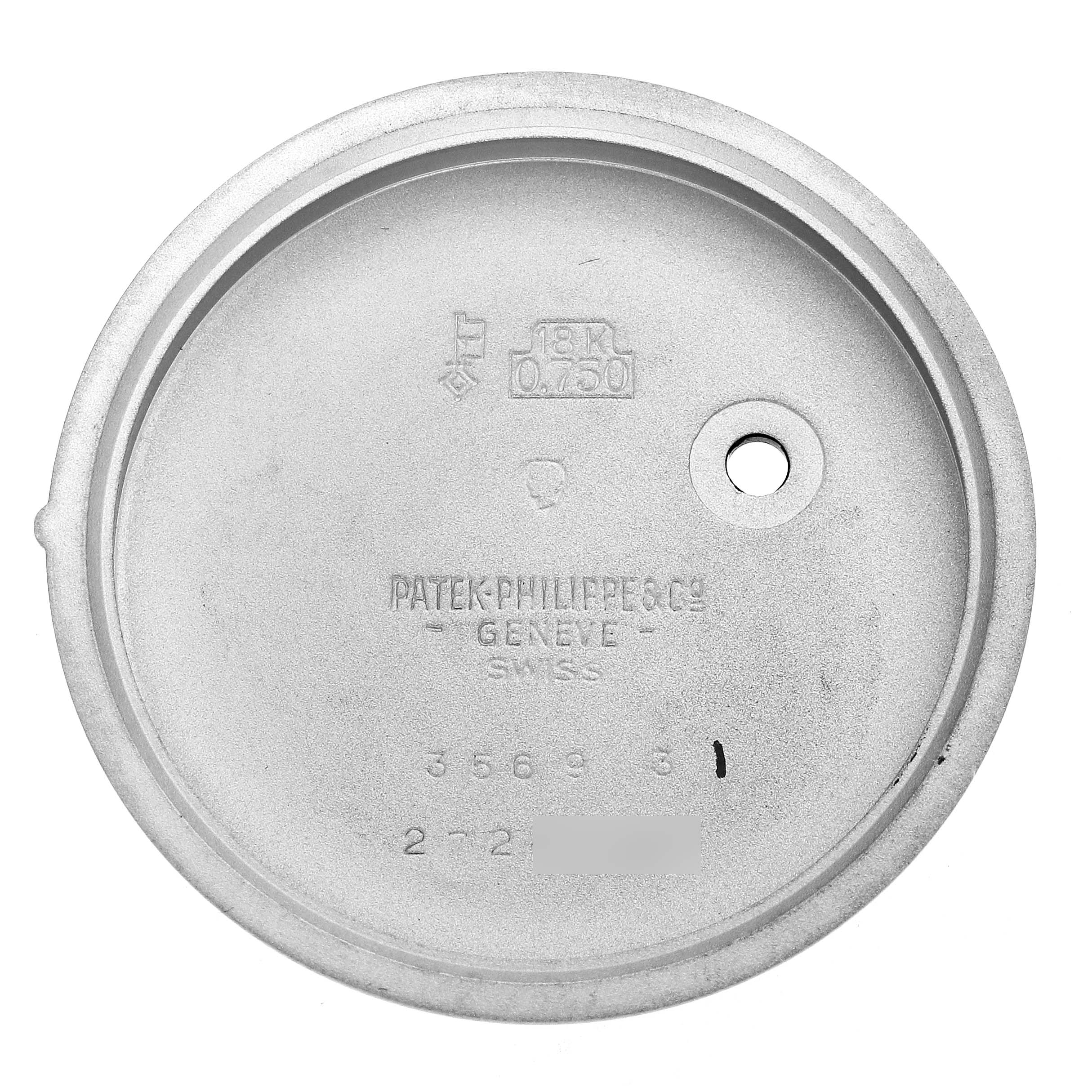 The image shows the inside of a vintage Patek Philippe watch case back, displaying engravings and hallmarks.