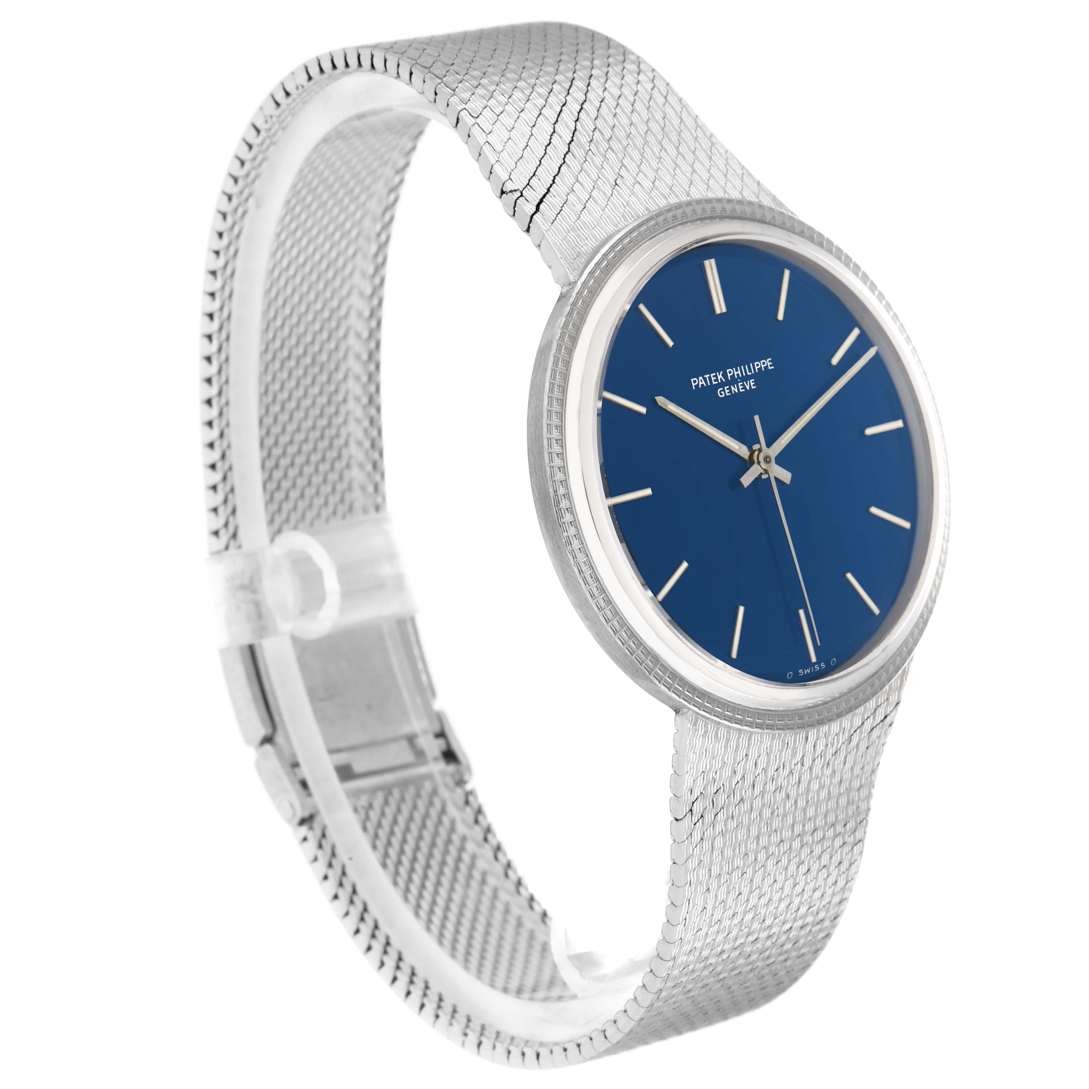 The Vintage Patek Philippe watch is pictured at a slight angle, showcasing its blue dial, silver hands, markers, and mesh bracelet.