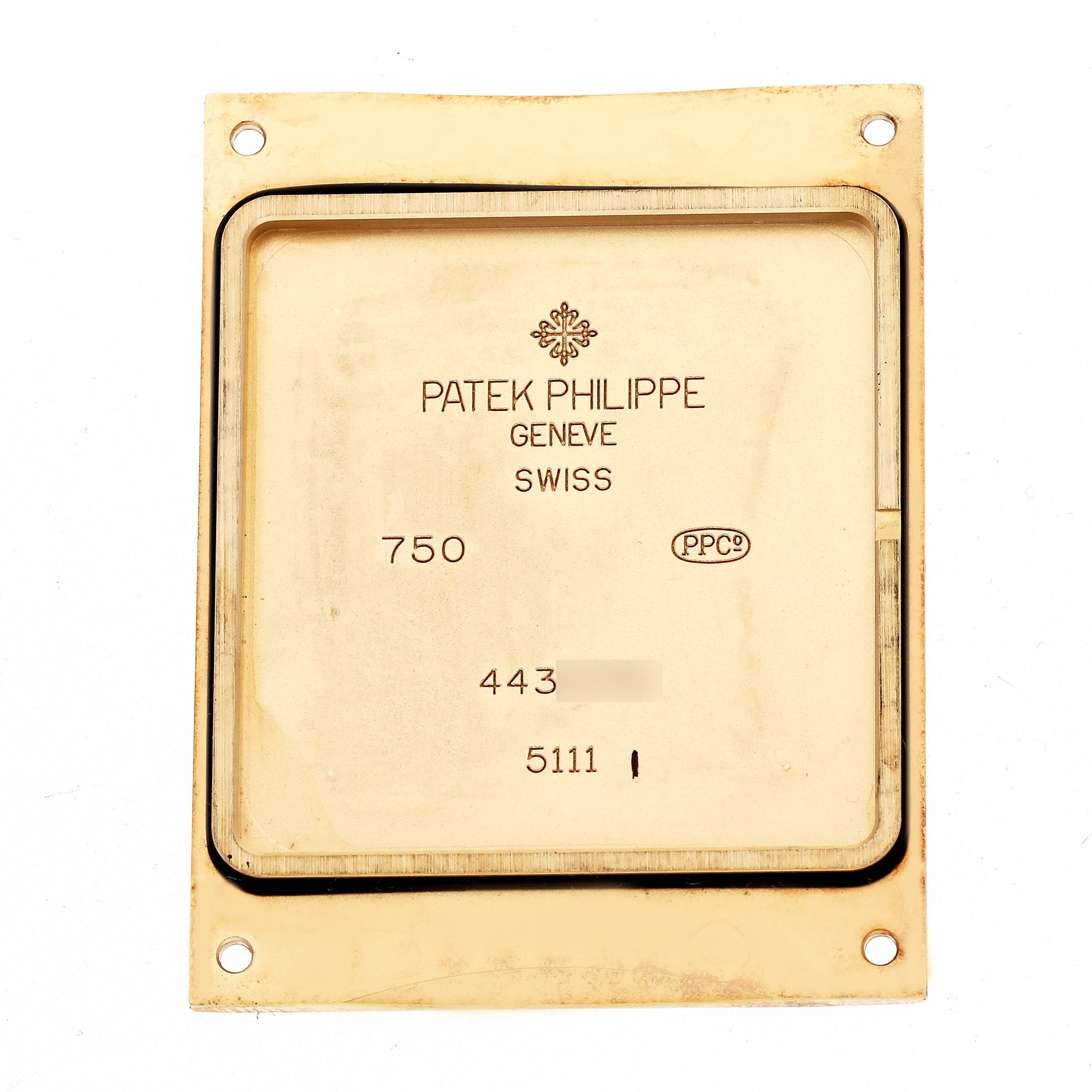 The image shows the backplate of a Patek Philippe Gondolo 5111J-001 Men
s Yellow Gold Silver Dial watch with text and markings, viewed from above.
