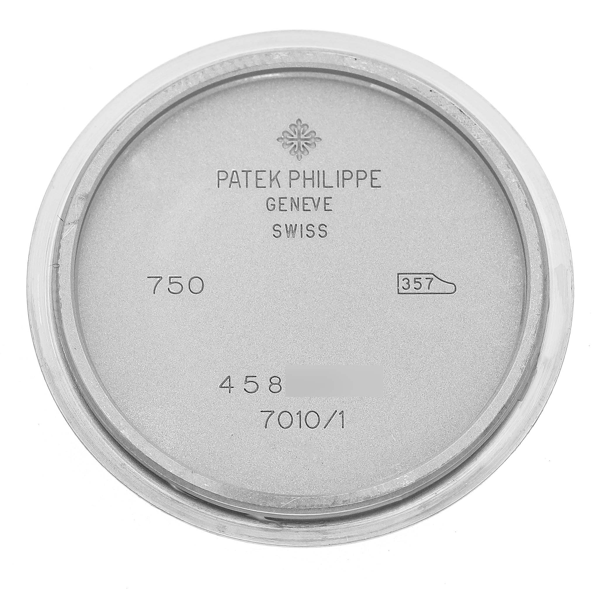The image shows the inner case back of a Patek Philippe Nautilus 7010/1G-001 Women's White Gold Silver Dial watch, displaying engravings and model numbers.