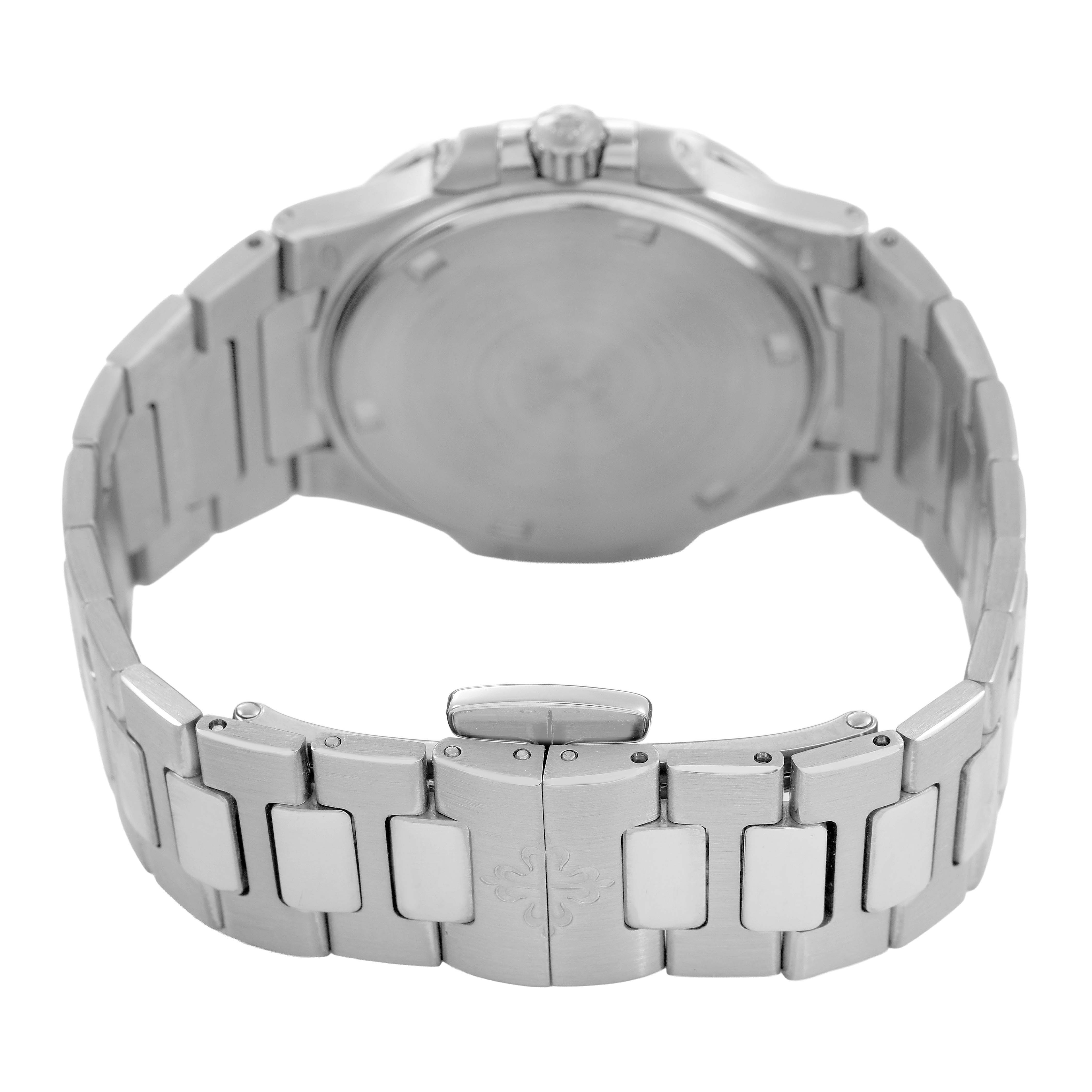 The image shows the back of a Patek Philippe Nautilus 7010/1G-001 Women's White Gold Silver Dial watch, highlighting the case back, crown, and stainless steel bracelet with clasp.