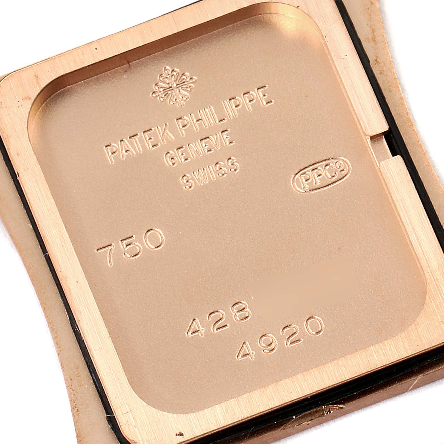 The image shows the backside of a Patek Philippe Twenty-4 4920R-10 Women's Rose Gold Brown Dial 4920R-10 Women's Rose Gold Brown Dial watch, displaying inscriptions and hallmarks.