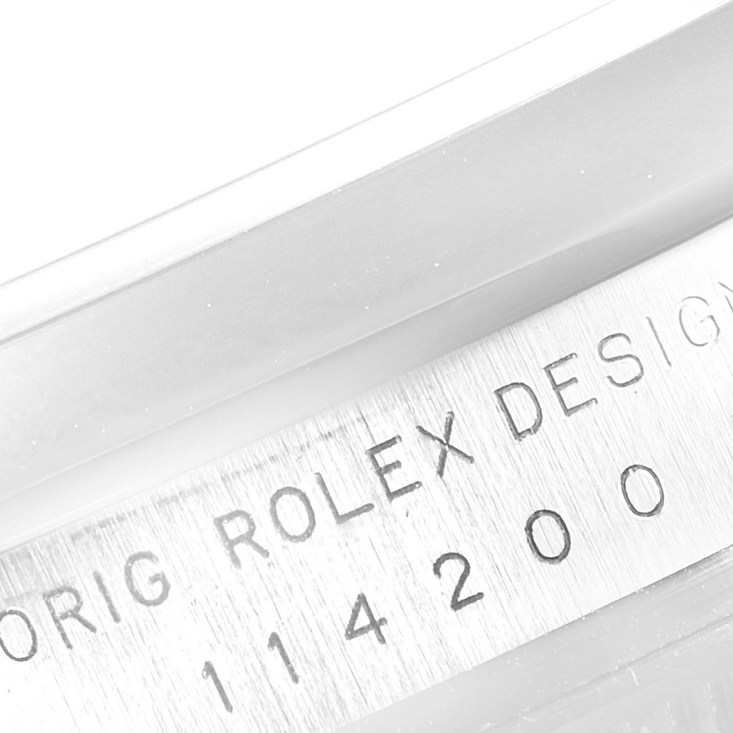 The image shows a close-up of the engraved serial number on the Rolex Air-King 114200 Men's Stainless Steel Blue Dial 114200 Men's Stainless Steel Blue Dial 114200 model.