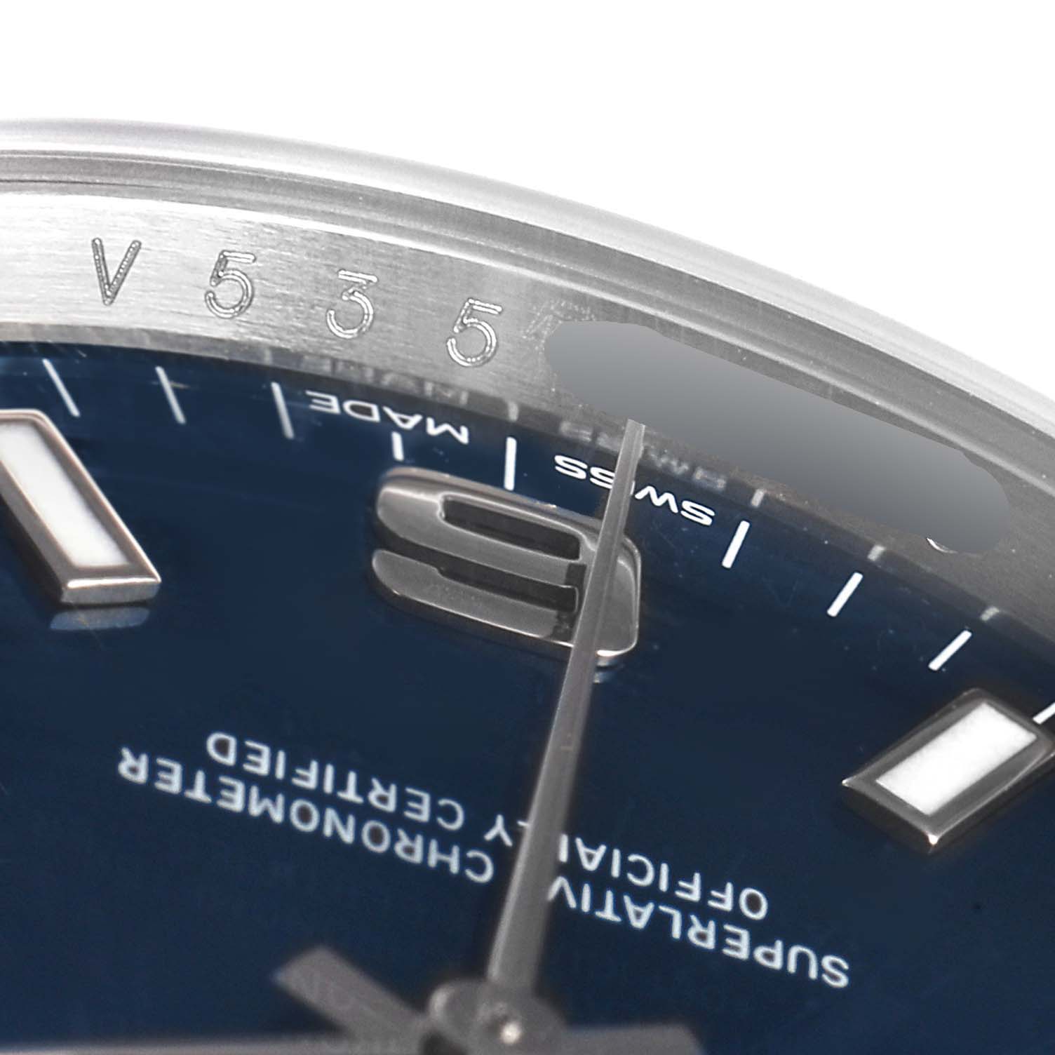 This image shows a close-up of the dial and edge of the bezel of a Rolex Air-King 114200 Men's Stainless Steel Blue Dial 114200 Men's Stainless Steel Blue Dial watch.