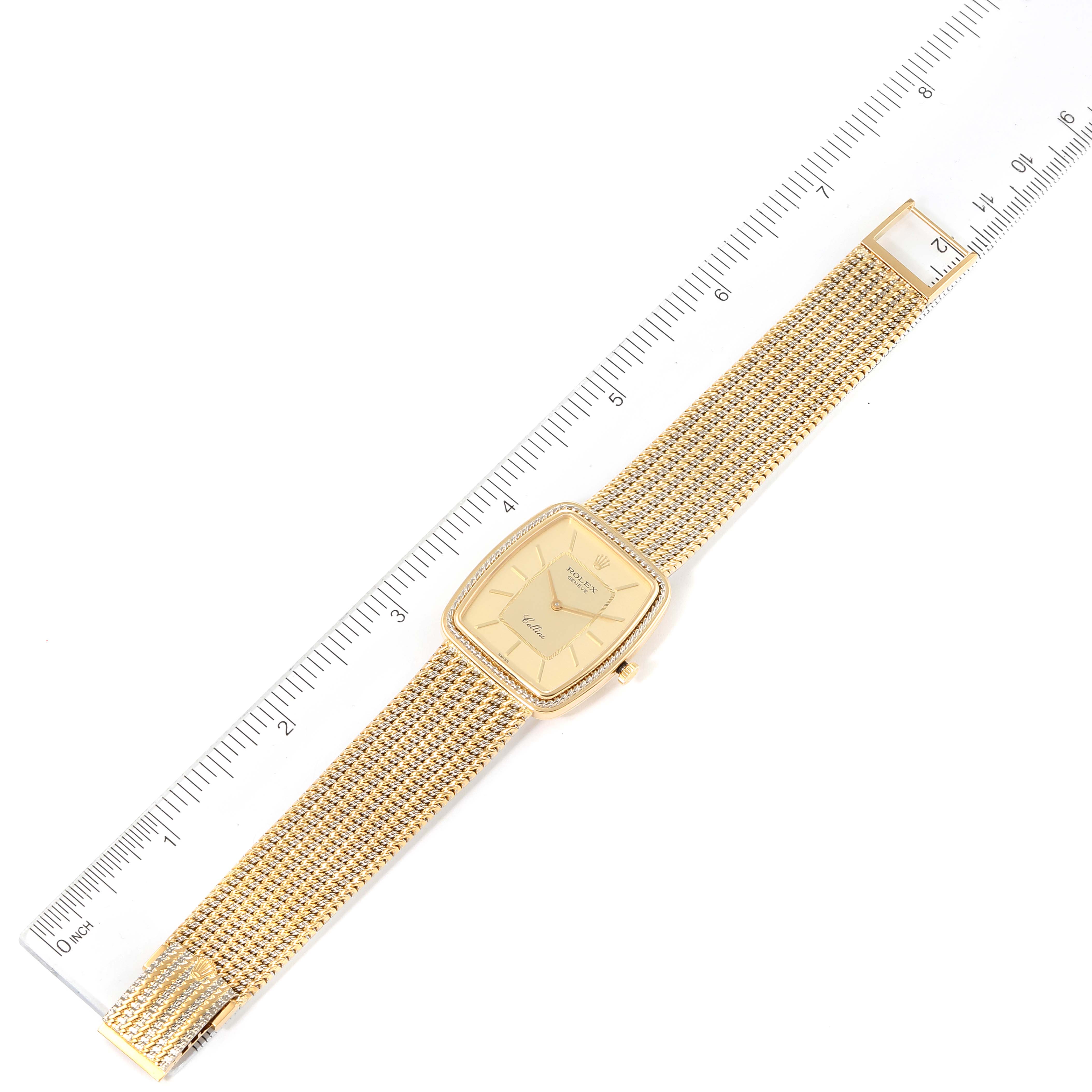 The Rolex Cellini 4340 Men's Yellow Gold Champagne Dial 4340 Men's Yellow Gold Champagne Dial watch is shown from the top view, displaying its dial, case, and bracelet, alongside a ruler for scale.
