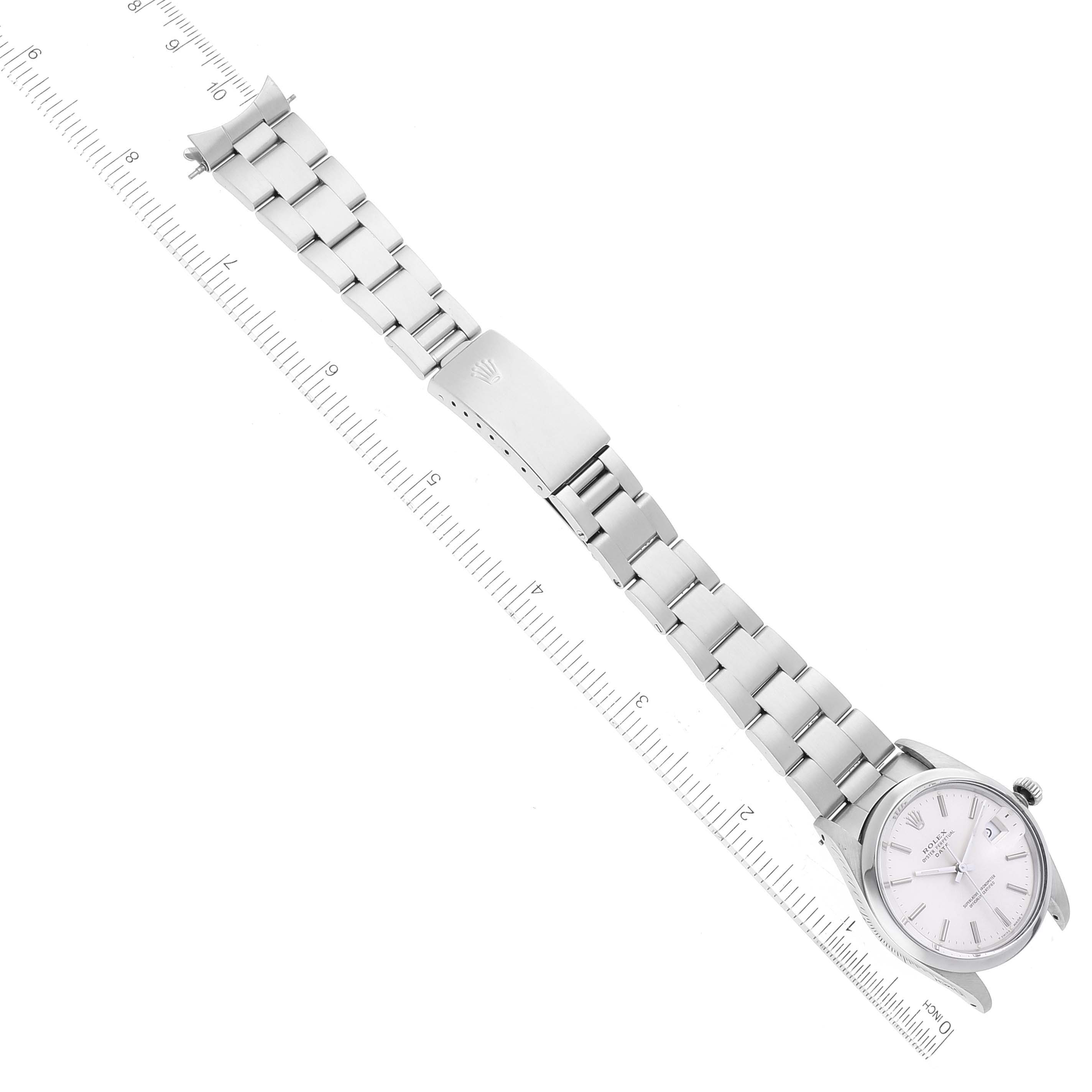 This image shows a top-down view of the Rolex Date 15000 Men's Stainless Steel Silver Dial 15000 Men's Stainless Steel Silver Dial model watch, displaying the face, bracelet, and clasp with a measuring scale.