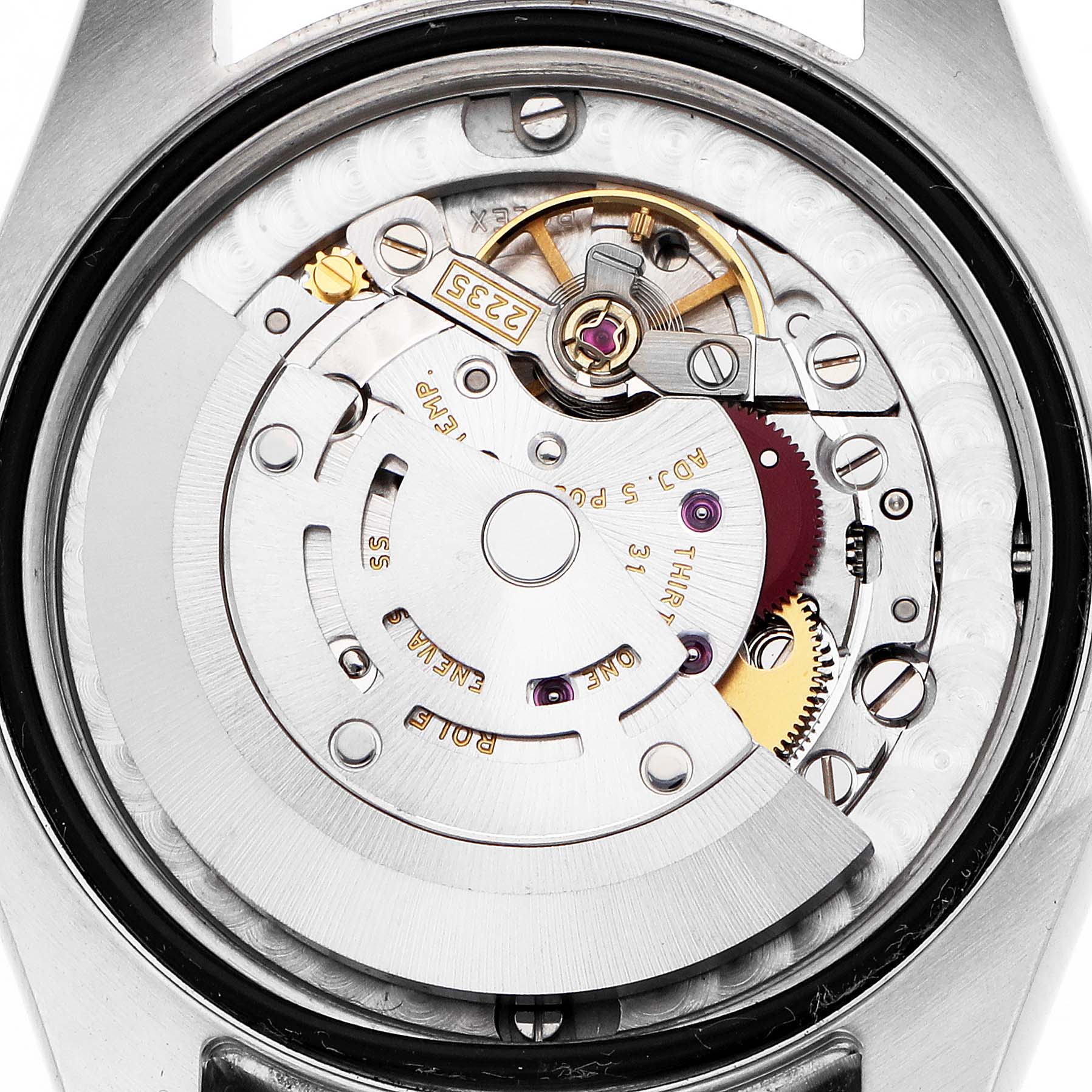 The image shows the movement of a Rolex Mid-Size 178344 Women
s Stainless Steel Silver Dial watch from a top-down angle, highlighting gears and the rotor.