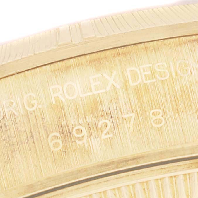 This close-up image shows the side of the bezel and engraved details on the Rolex President 69278 Women's Yellow Gold Champagne Dial 69278 Women's Yellow Gold Champagne Dial model watch.