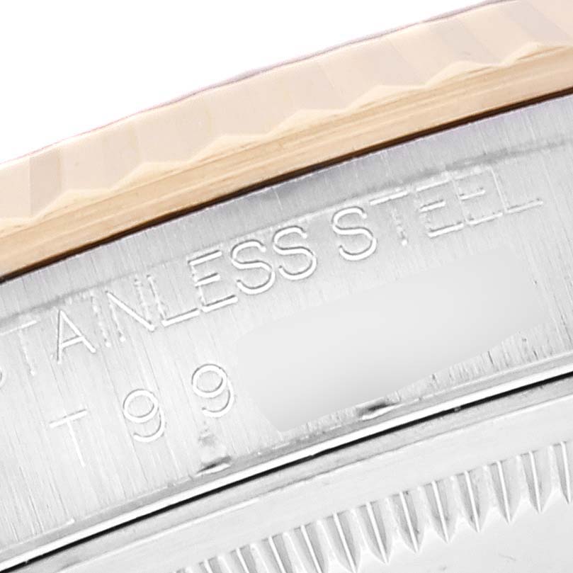 The image shows a close-up of the side engraving and part of the bezel on a Rolex Datejust 16233 Men's Steel and Gold (two tone) Blue Dial 16233 Men's Steel and Gold (two tone) Blue Dial model.