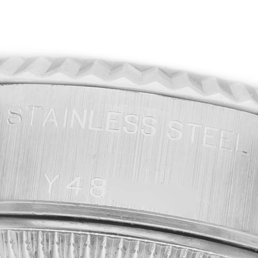 The image shows a close-up of the stainless steel case side of a Rolex Datejust 79174 Women's Stainless Steel Silver Dial, featuring engraved text.