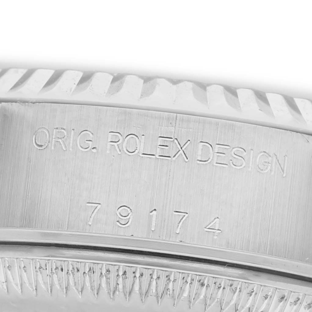 The image shows a close-up of the case side of a Rolex Datejust 79174 Women's Stainless Steel Silver Dial, highlighting the engraving and part of the bezel.