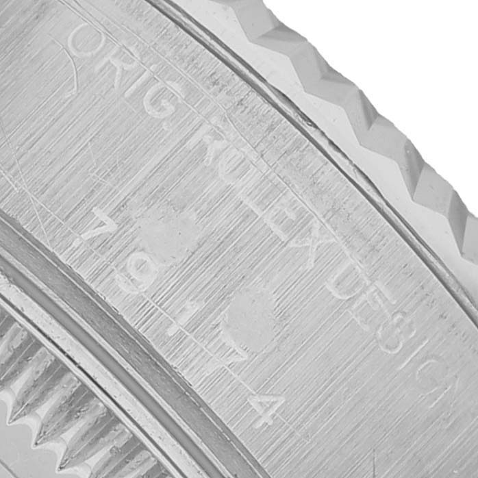 The image shows a close-up of the side bezel, detailing the serial engraving on a Rolex Datejust 79174 Women's Stainless Steel Blue Dial watch.