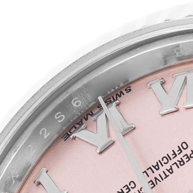 The image shows a close-up of the bezel, part of the dial, and hands of a Rolex Datejust 179174 Women's Stainless Steel Pink Dial watch.