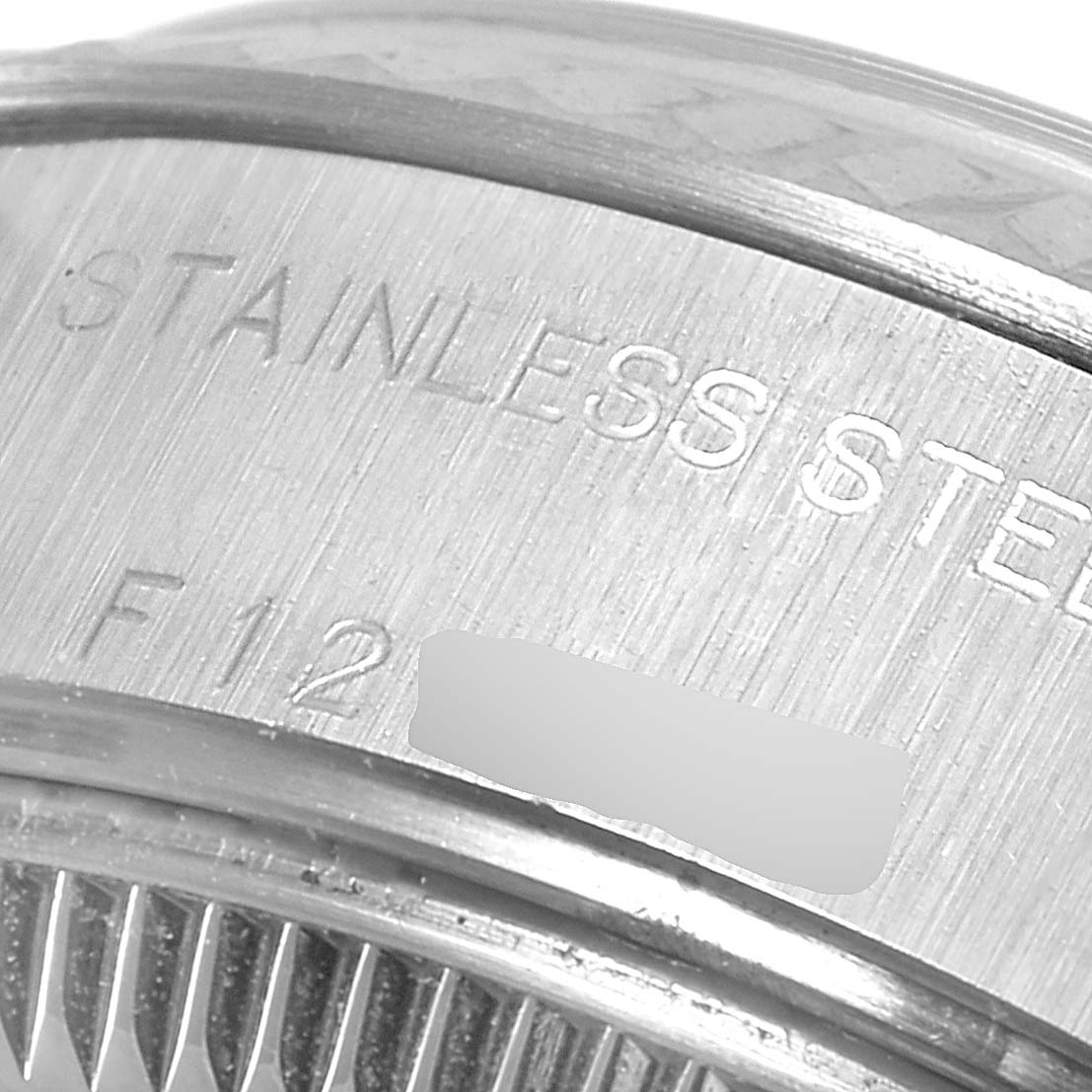 The image shows a close-up of the stainless steel case back of a Rolex Datejust 79174 Women
s Stainless Steel Silver Dial 79174 Women
s Stainless Steel Silver Dial watch.