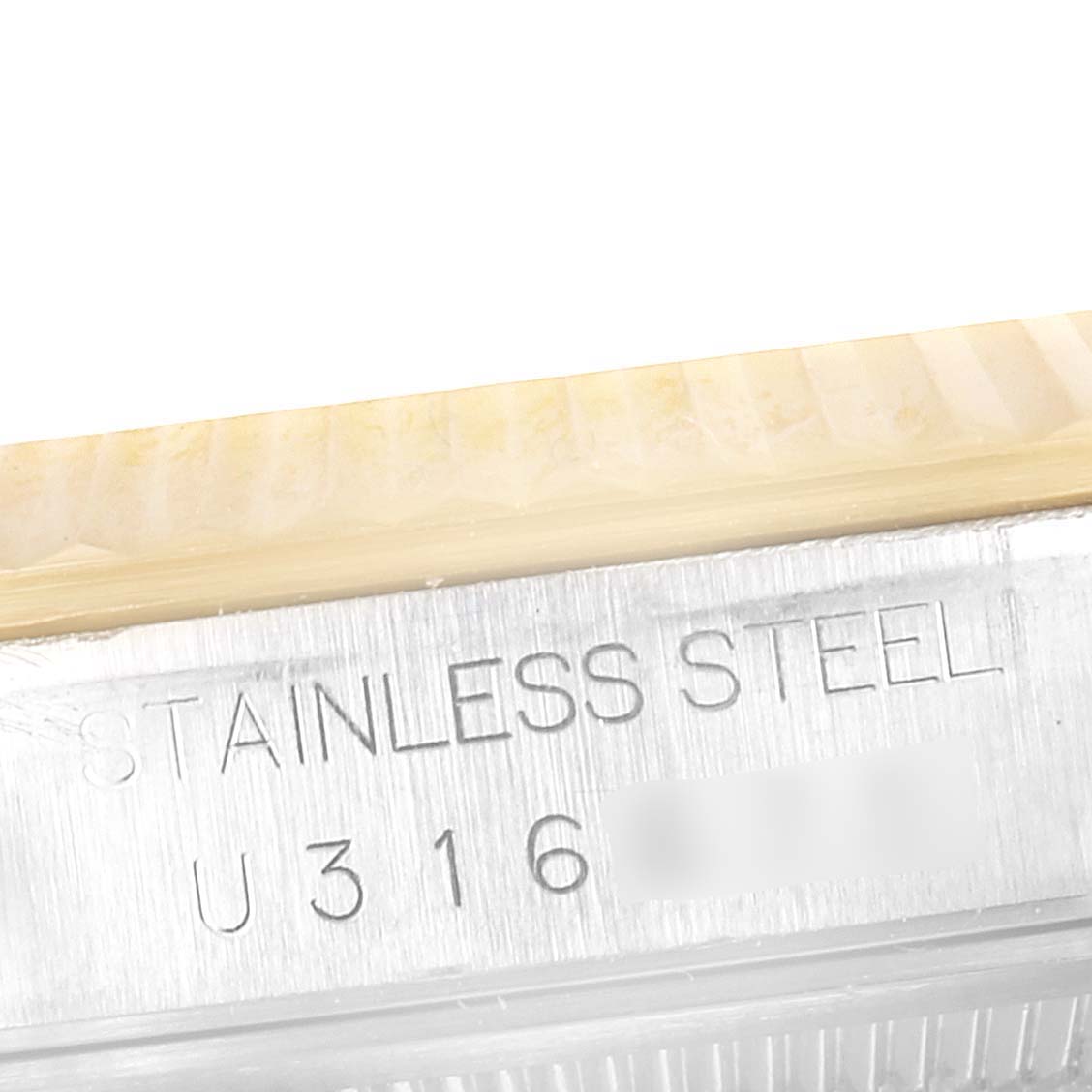 This image shows a close-up of the side case of a Rolex Datejust 16233 Men's Steel and Gold (two tone) Champagne Dial 16233 Men's Steel and Gold (two tone) Champagne Dial watch, displaying the stainless steel marking and partial serial number.