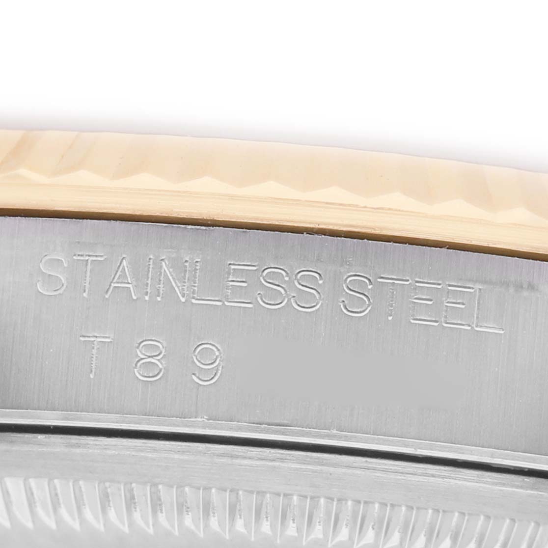 The image shows a close-up of the side of a Rolex Datejust 16233 Men's Stainless Steel Champagne Dial watch, highlighting its stainless steel case with an engraving.