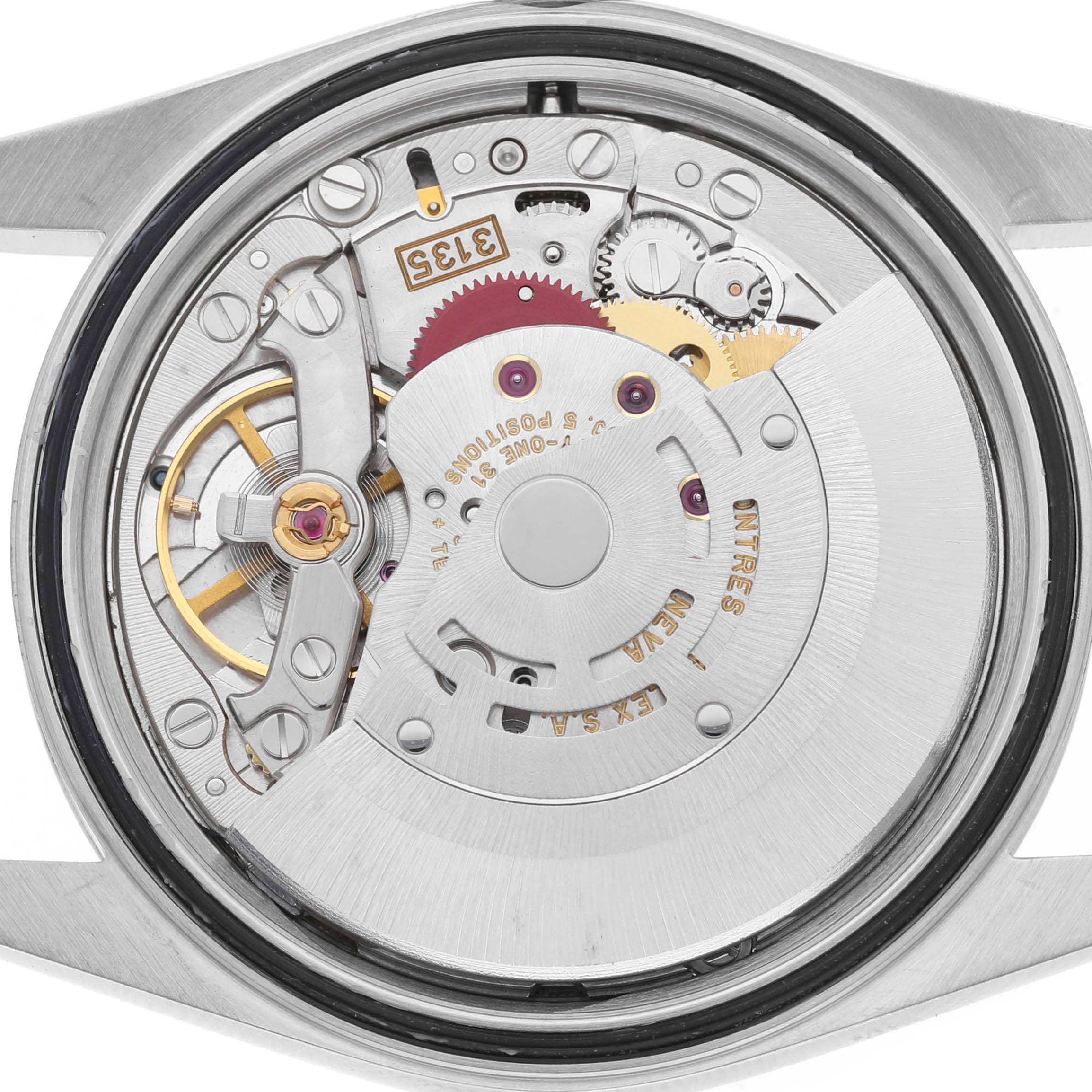 The image shows the movement of a Rolex Datejust 16233 Men's Stainless Steel Champagne Dial watch viewed from the back, revealing intricate gears and components.