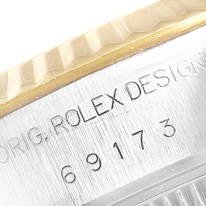 The image shows a close-up of the engraved side and textured bezel of the Rolex Datejust 69173 Women
s Steel and Gold (two tone) Champagne Dial 69173 Women
s Steel and Gold (two tone) Champagne Dial watch.