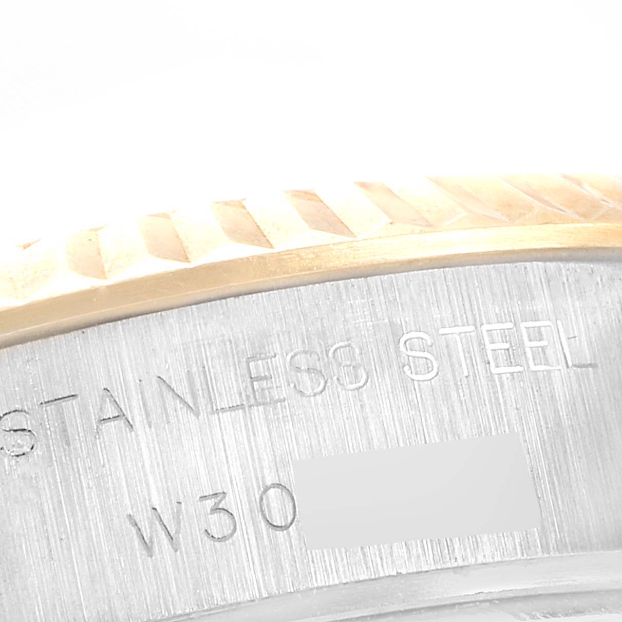 This close-up image shows the side of the stainless steel case and part of the bezel of a Rolex Datejust 69173 Women
s Steel and Gold (two tone) Champagne Dial 69173 Women
s Steel and Gold (two tone) Champagne Dial watch.