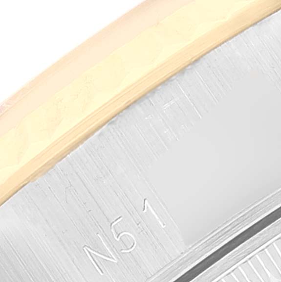 This close-up image shows part of the bezel and casing edge of a Rolex Datejust 69173 Women's Steel and Gold (two tone) Champagne Dial 69173 Women's Steel and Gold (two tone) Champagne Dial watch.