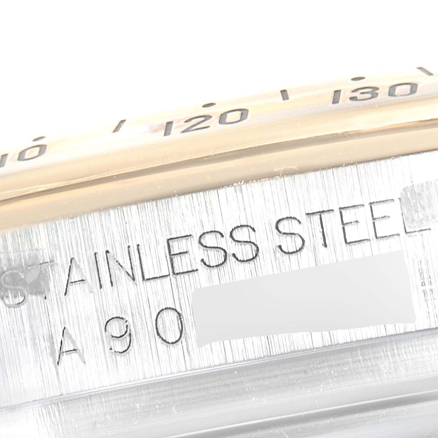 The image shows a close-up view of the side of a Rolex Daytona 16523 Men
s Steel and Gold (two tone) White Dial 16523 Men
s Steel and Gold (two tone) White Dial watch, highlighting the "STAINLESS STEEL" engraving.