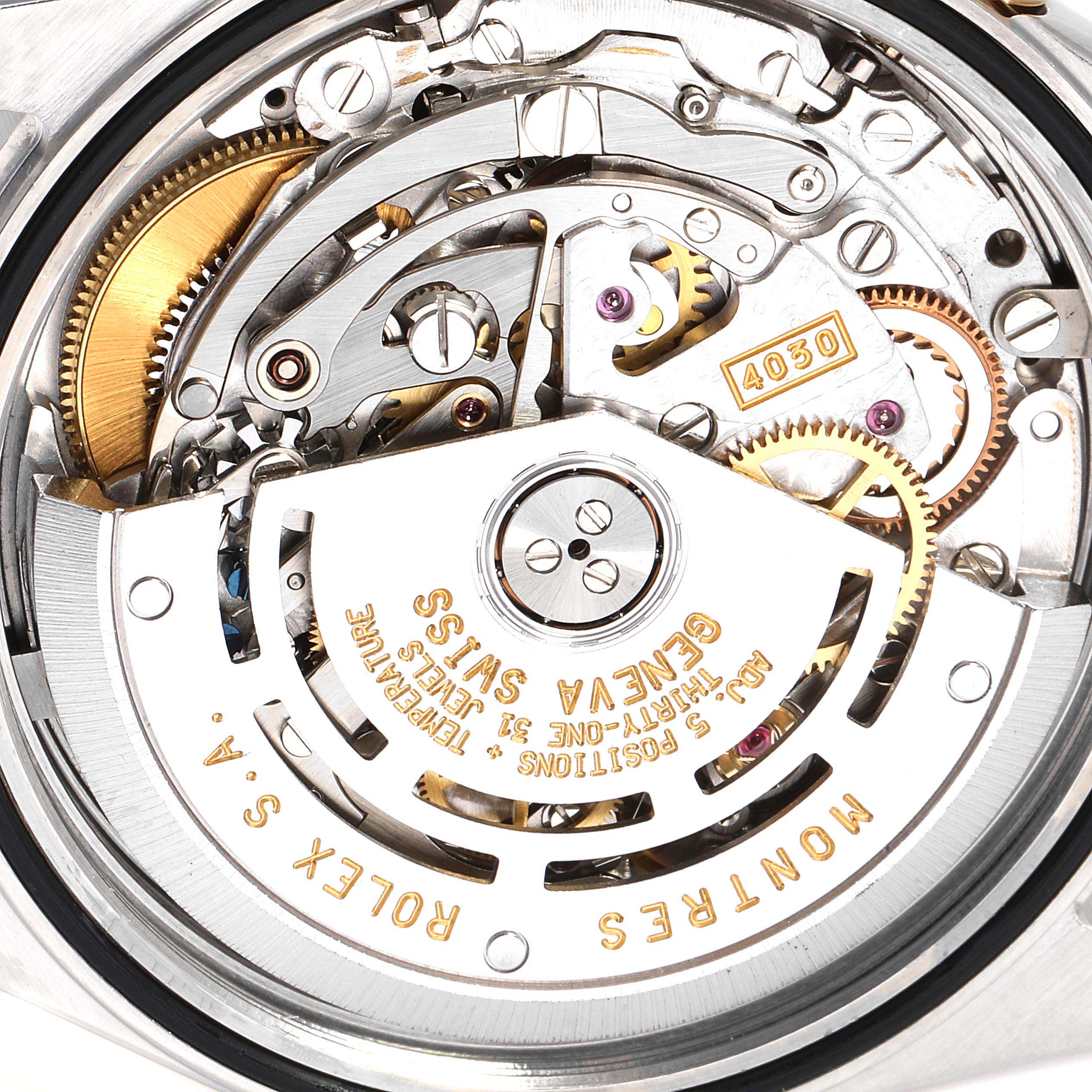 This image shows a close-up view of the Rolex Daytona 16523 Men
s Steel and Gold (two tone) White Dial 16523 Men
s Steel and Gold (two tone) White Dial watch
s intricate movement and inner mechanics.