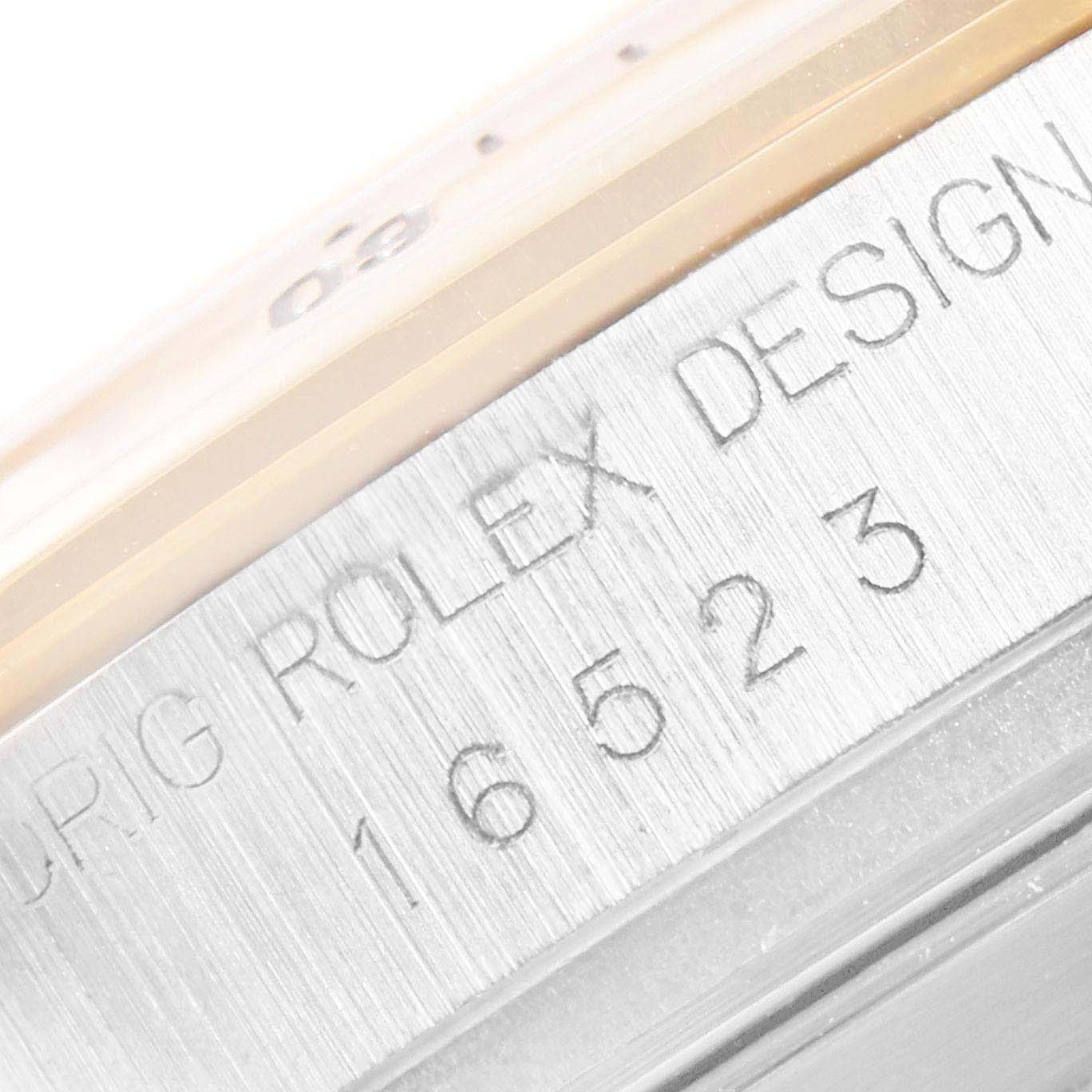 This close-up image shows the engraved model number and design markings on the case side of a Rolex Daytona 16523 Men
s Steel and Gold (two tone) White Dial 16523 Men
s Steel and Gold (two tone) White Dial watch.