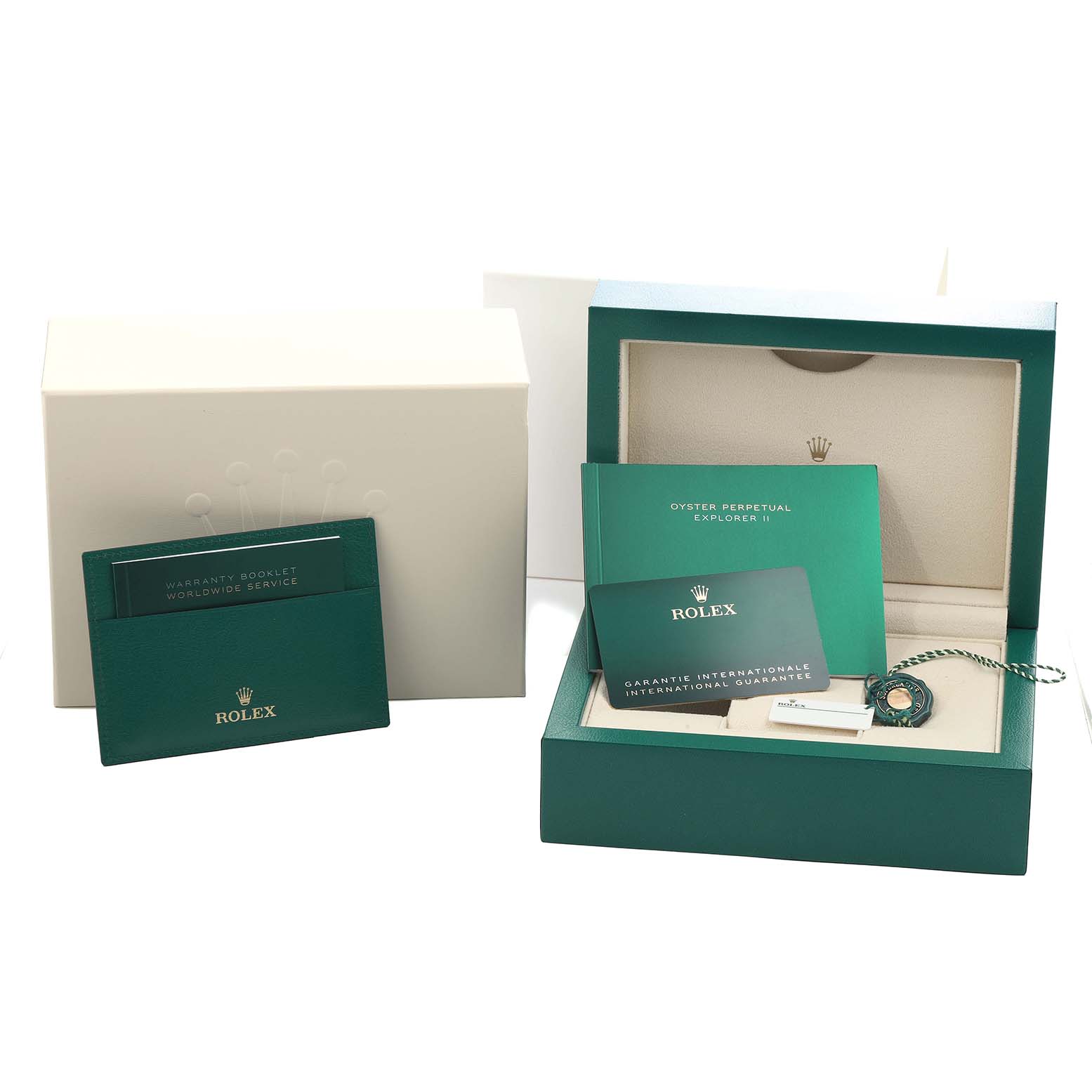 The image shows a Rolex Explorer 226570 Men
s Stainless Steel White Dial model packaging with warranty booklets, international guarantee card, and a tag.