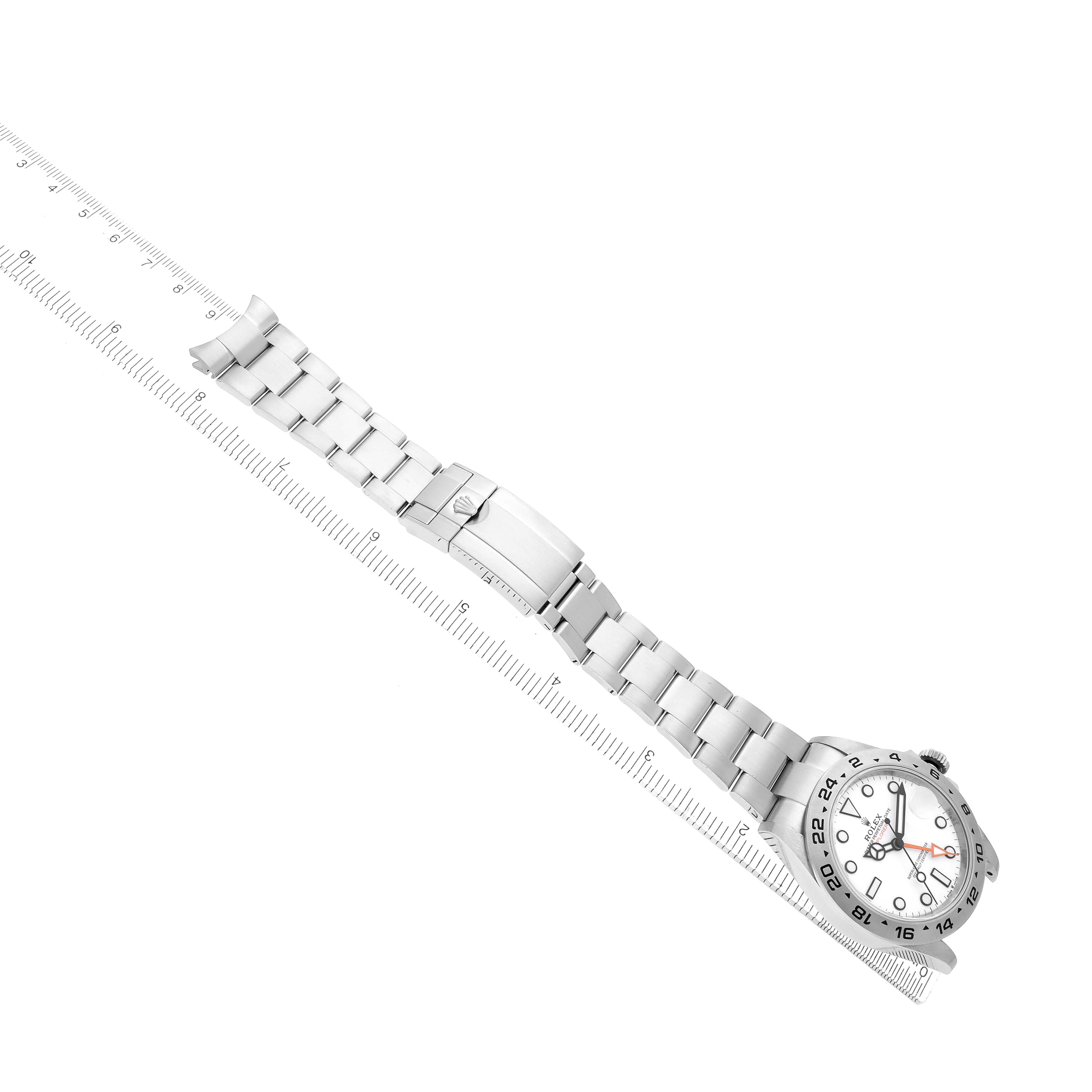 The Rolex Explorer 226570 Men
s Stainless Steel White Dial watch is shown from a top-down angle, displaying the face, bezel, bracelet, and clasp fully extended.