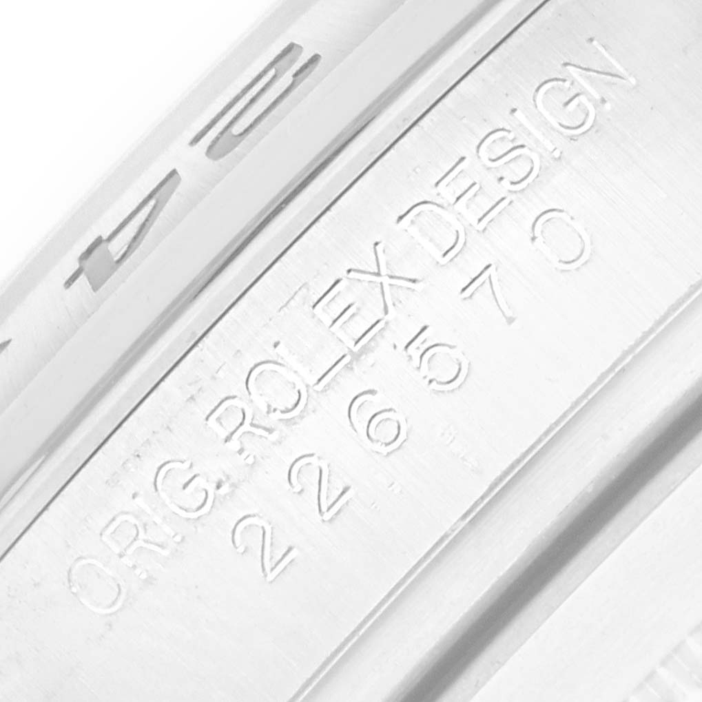 The image shows a close-up of the inner bezel of a Rolex Explorer 226570 Men
s Stainless Steel White Dial, highlighting the engraved model details.