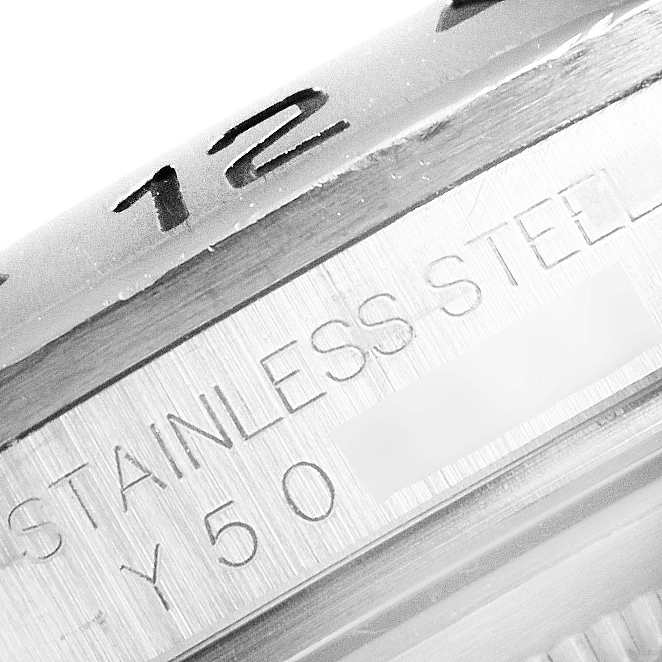 The image shows a close-up of the bezel and part of the casing with engraved text on the Rolex Explorer 16570 Men
s Stainless Steel Black Dial 16570 Men
s Stainless Steel Black Dial watch.