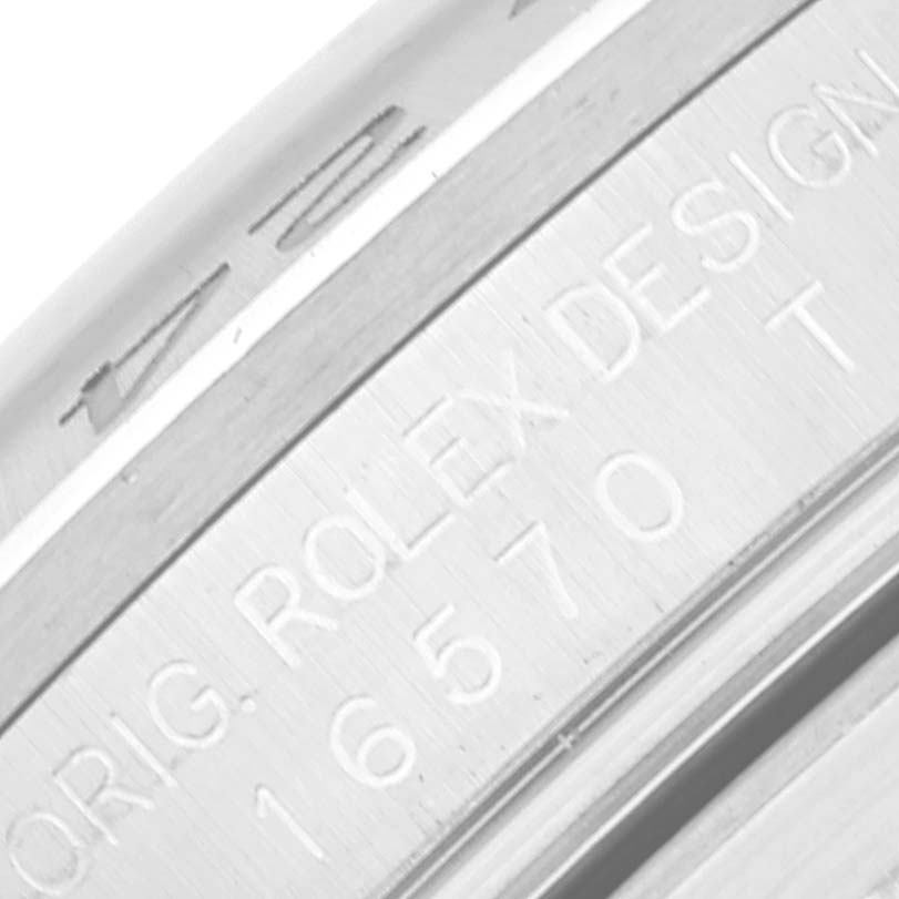 This image shows a close-up of the engraved serial and model numbers on the edge of a Rolex Explorer 16570 Men's Stainless Steel Black Dial 16570 Men's Stainless Steel Black Dial watch.