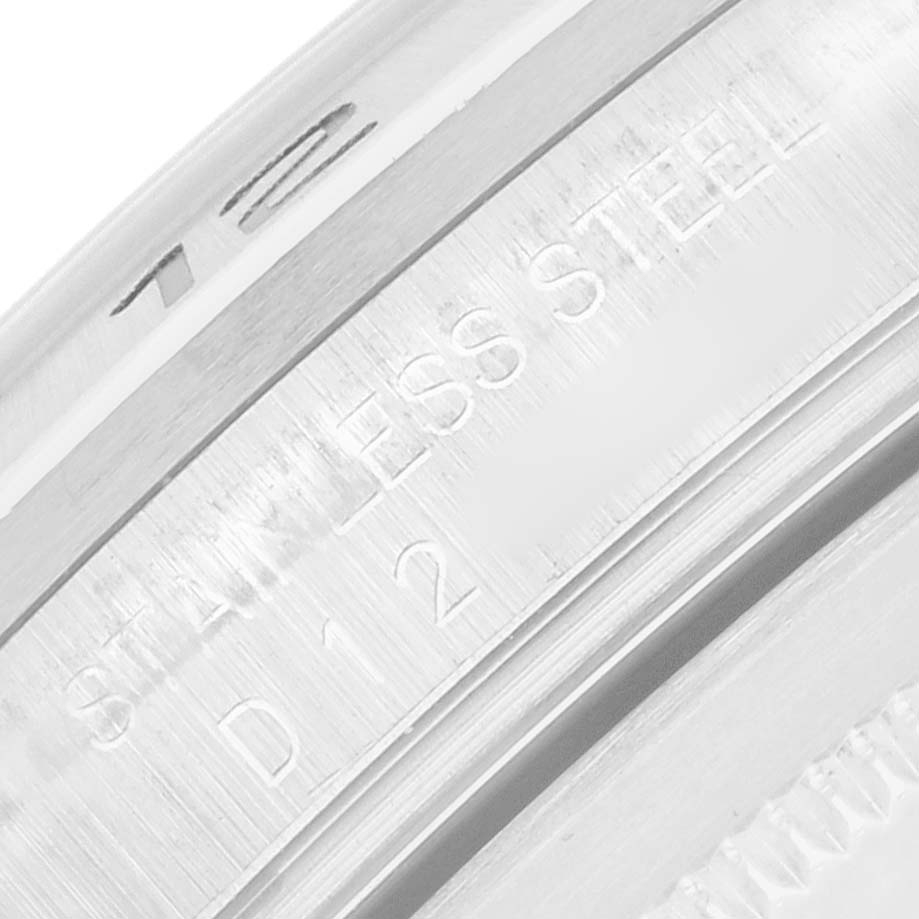 The image shows a close-up of the stainless steel case edge of a Rolex Explorer 16570 Men
s Stainless Steel White Dial watch.