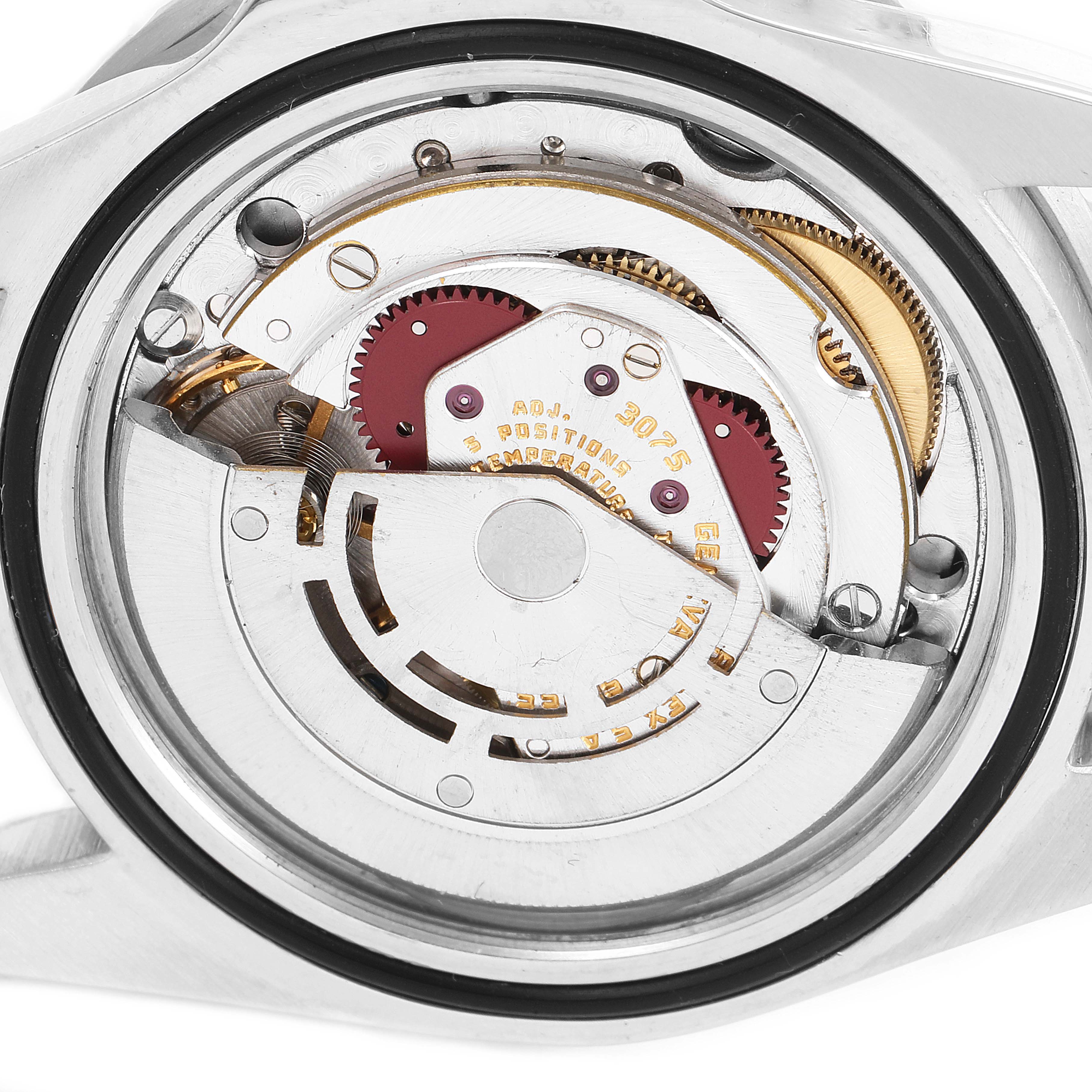 The image shows the inner mechanism of the Vintage Collection watch by Rolex, viewed from the back case with gears and components visible.