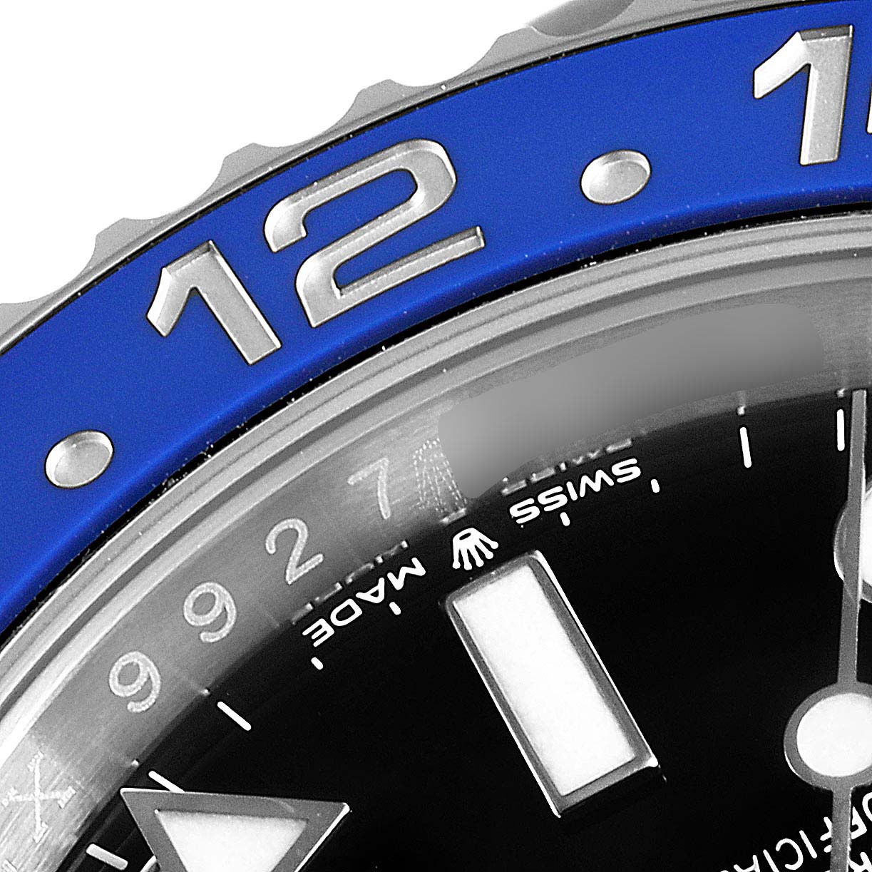 This close-up of a Rolex GMT-Master 126710 Men
s Stainless Steel Black Dial 126710 Men
s Stainless Steel Black Dial watch highlights the bezel and part of the face with the "Swiss Made" text.