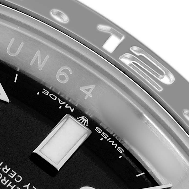 The image shows a close-up of the bezel and dial edge of a Rolex GMT-Master 126710 Men
s Stainless Steel Black Dial watch, highlighting the 12 o
clock marker.