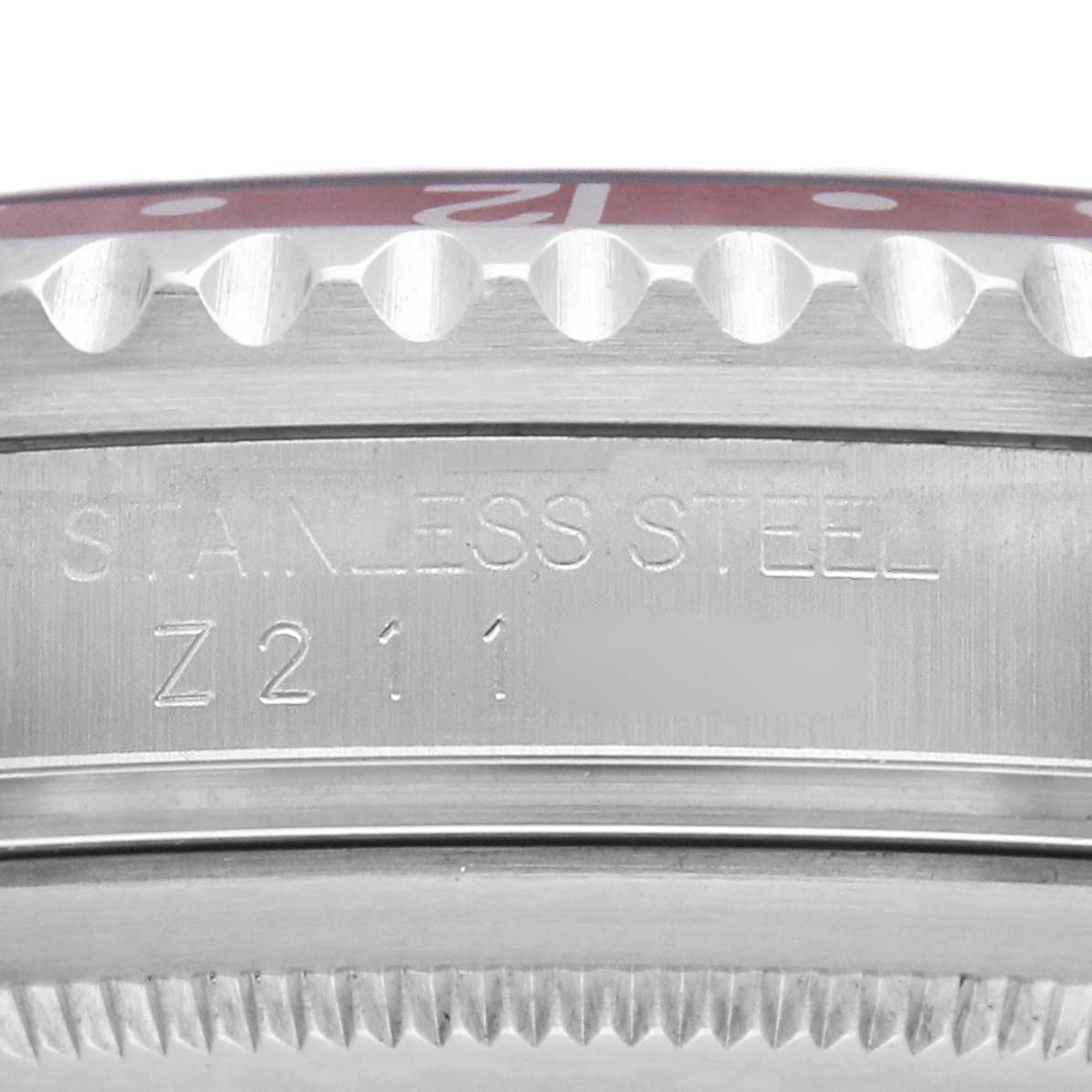 The image shows a close-up of the side view of the Rolex GMT-Master 16710 Men
s Stainless Steel Black Dial, focusing on the bezel edge and engraved stainless steel text.