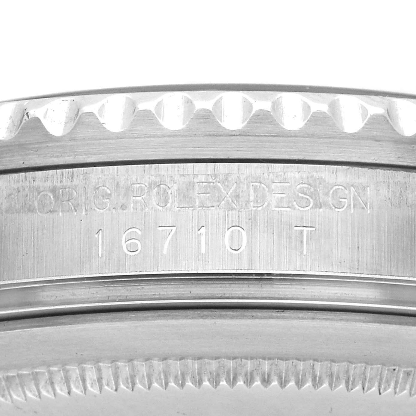 The image shows a close-up of the side view of a Rolex GMT-Master 16710 Men
s Stainless Steel Black Dial model, highlighting the engraved serial number and bezel edge.
