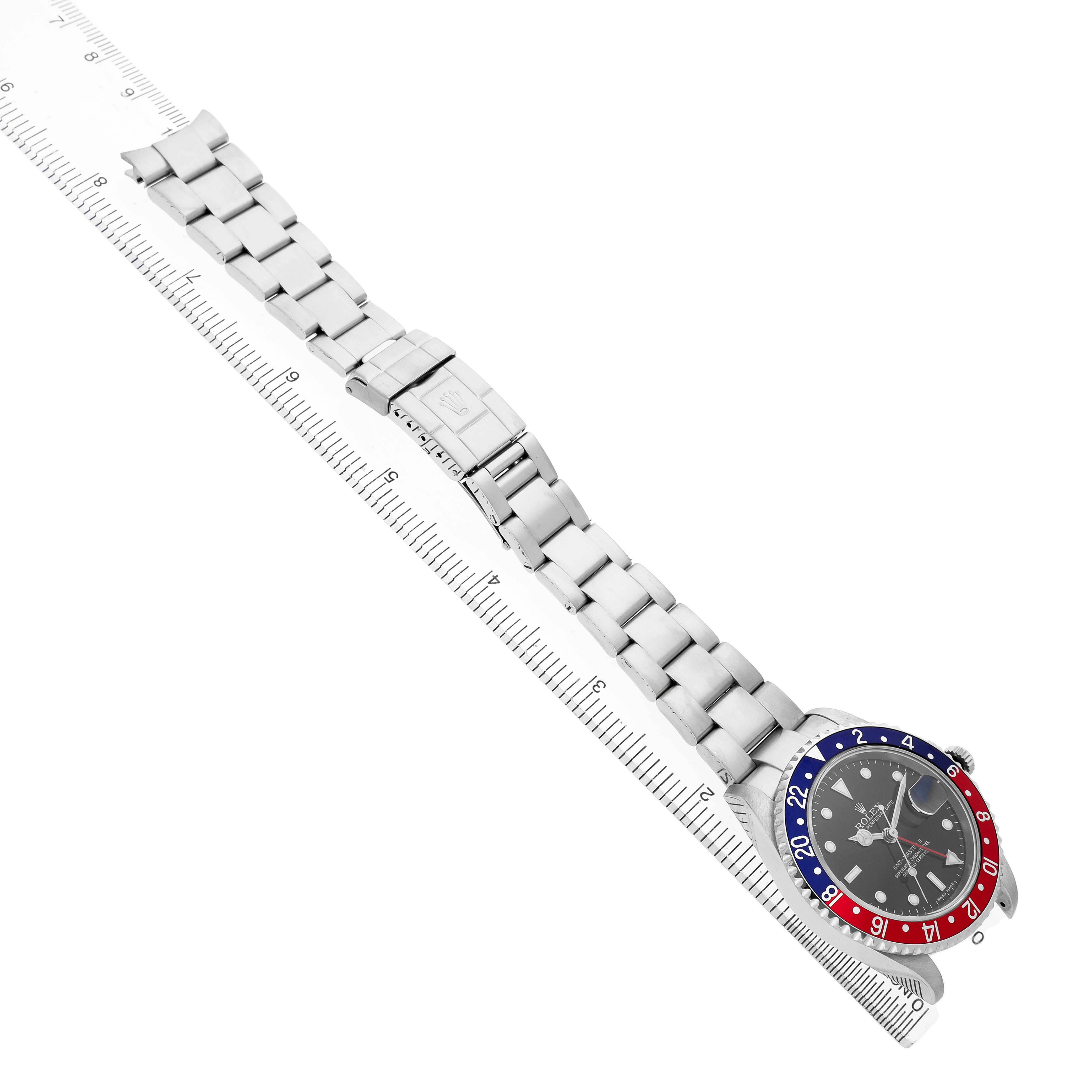 The image shows a top-down view of a Rolex GMT-Master 16710 T Men's Stainless Steel Black Dial watch, highlighting its bracelet and bezel.