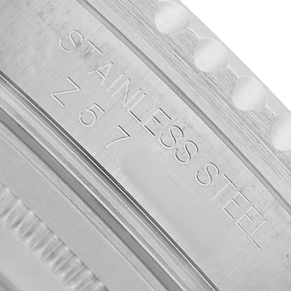 The image shows a close-up of the stainless steel case edge with engravings on the Rolex GMT-Master 16710 T Men's Stainless Steel Black Dial.