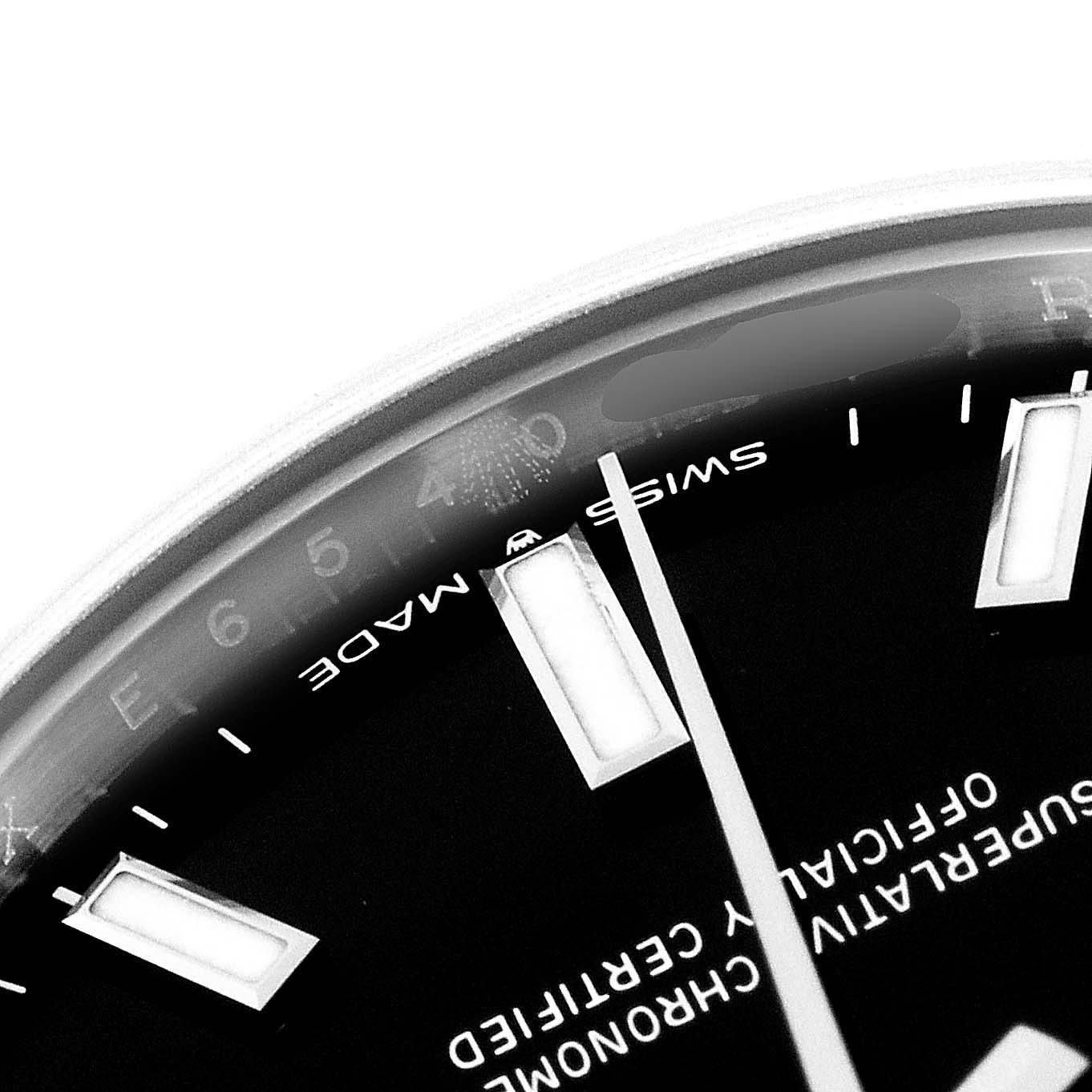 This close-up angle of the Rolex Mid-Size 277200 Women's Stainless Steel Black Dial 277200 Women's Stainless Steel Black Dial watch shows part of the dial, the minute and hour markers, and the "Swiss Made" text.