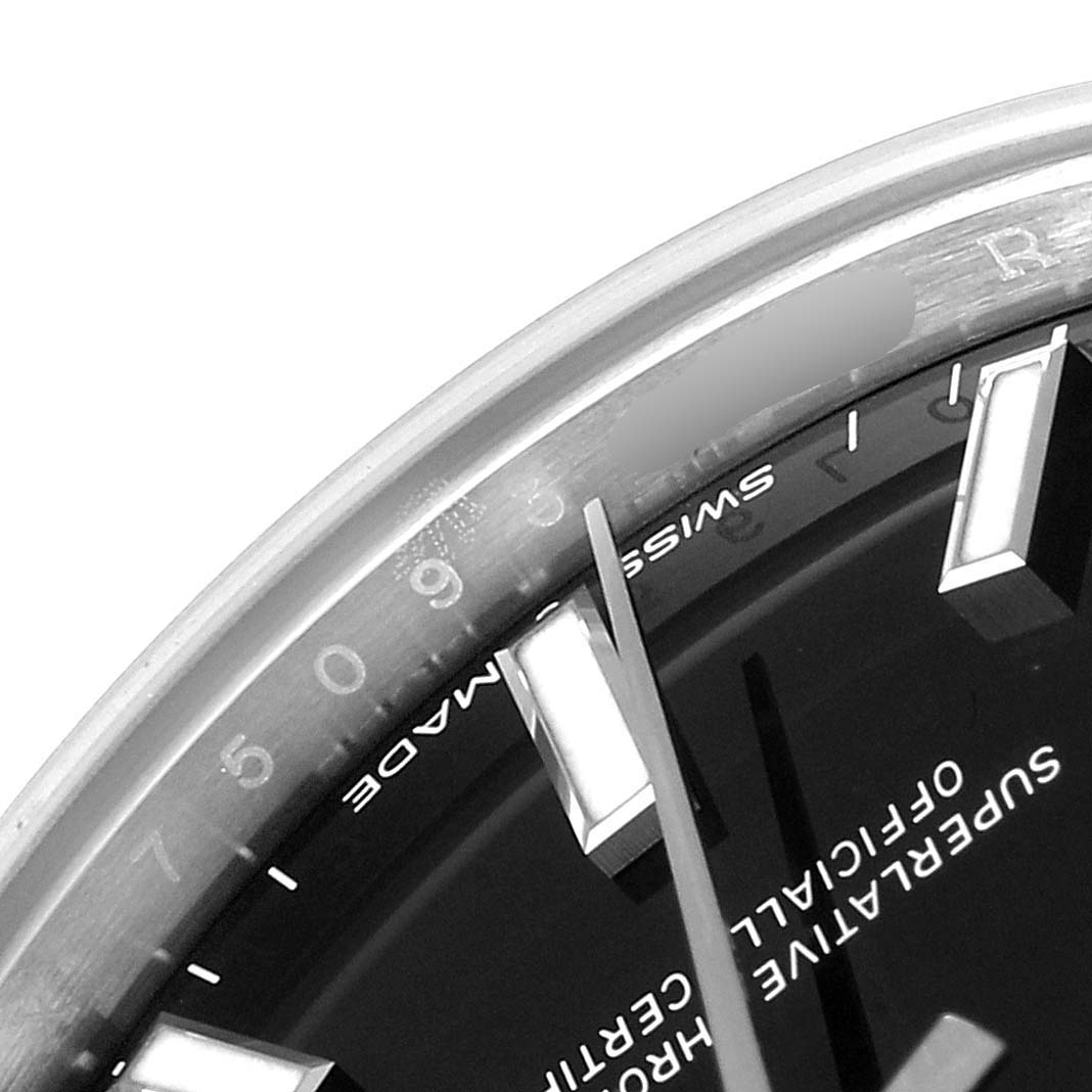 This close-up image of a Mid-Size Rolex watch shows part of the dial, "Swiss Made" marking, and some hour markers.