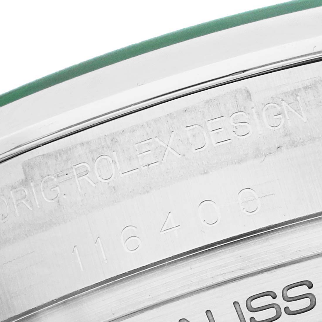 The image shows a close-up of the outer case edge and engraving on a Rolex Milgauss 116400 Men's Stainless Steel Blue Dial.