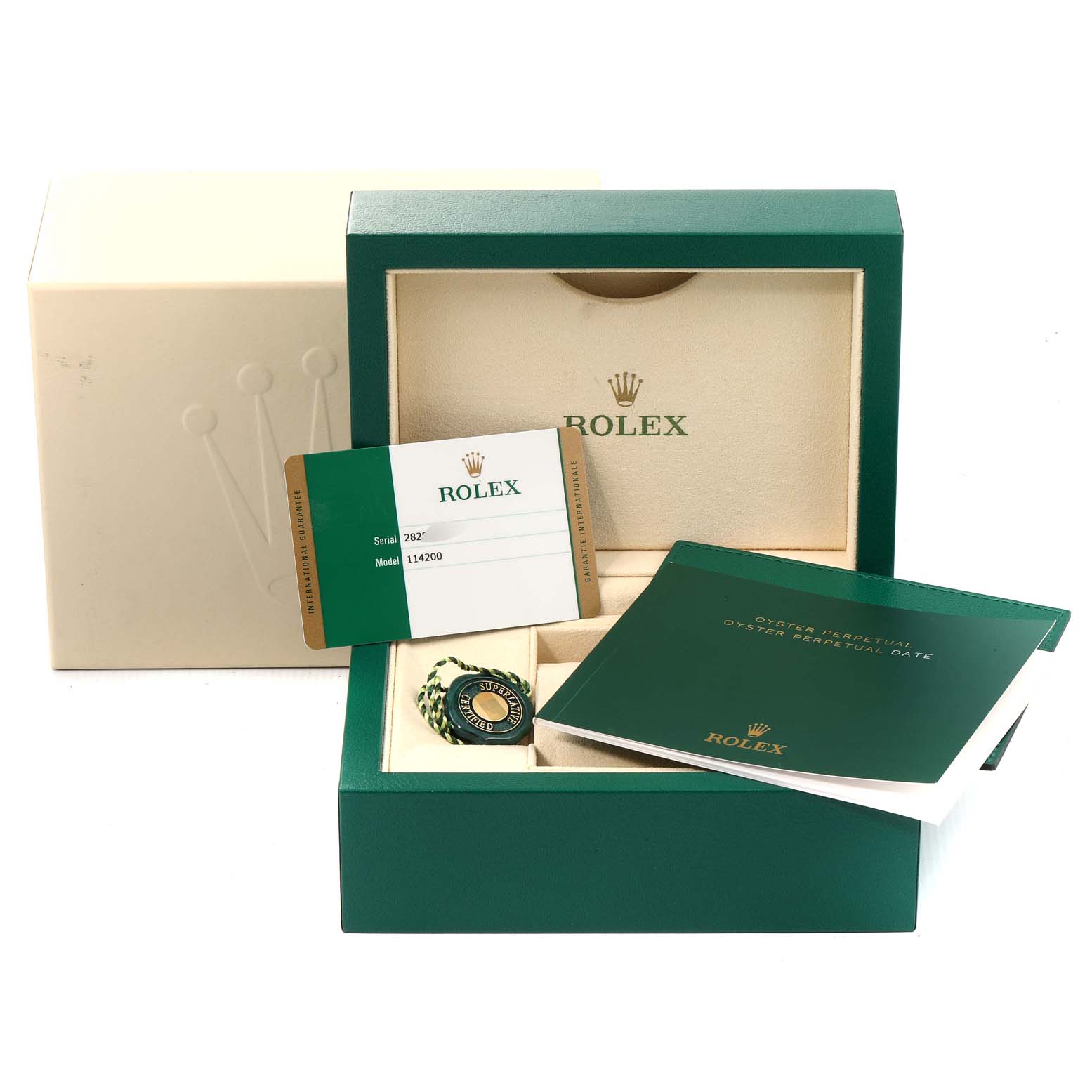 The image shows the open box of a Rolex Oyster Perpetual 114200 Men
s Stainless Steel Green Dial 114200 Men
s Stainless Steel Green Dial watch, featuring the watch, warranty card, booklet, and associated tags.