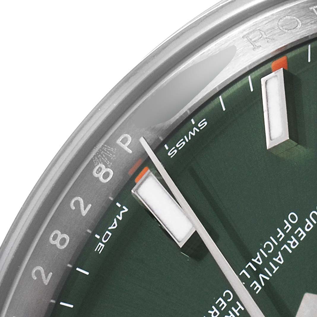 This image shows a close-up of the green dial and markers of a Rolex Oyster Perpetual 114200 Men
s Stainless Steel Green Dial 114200 Men
s Stainless Steel Green Dial watch.