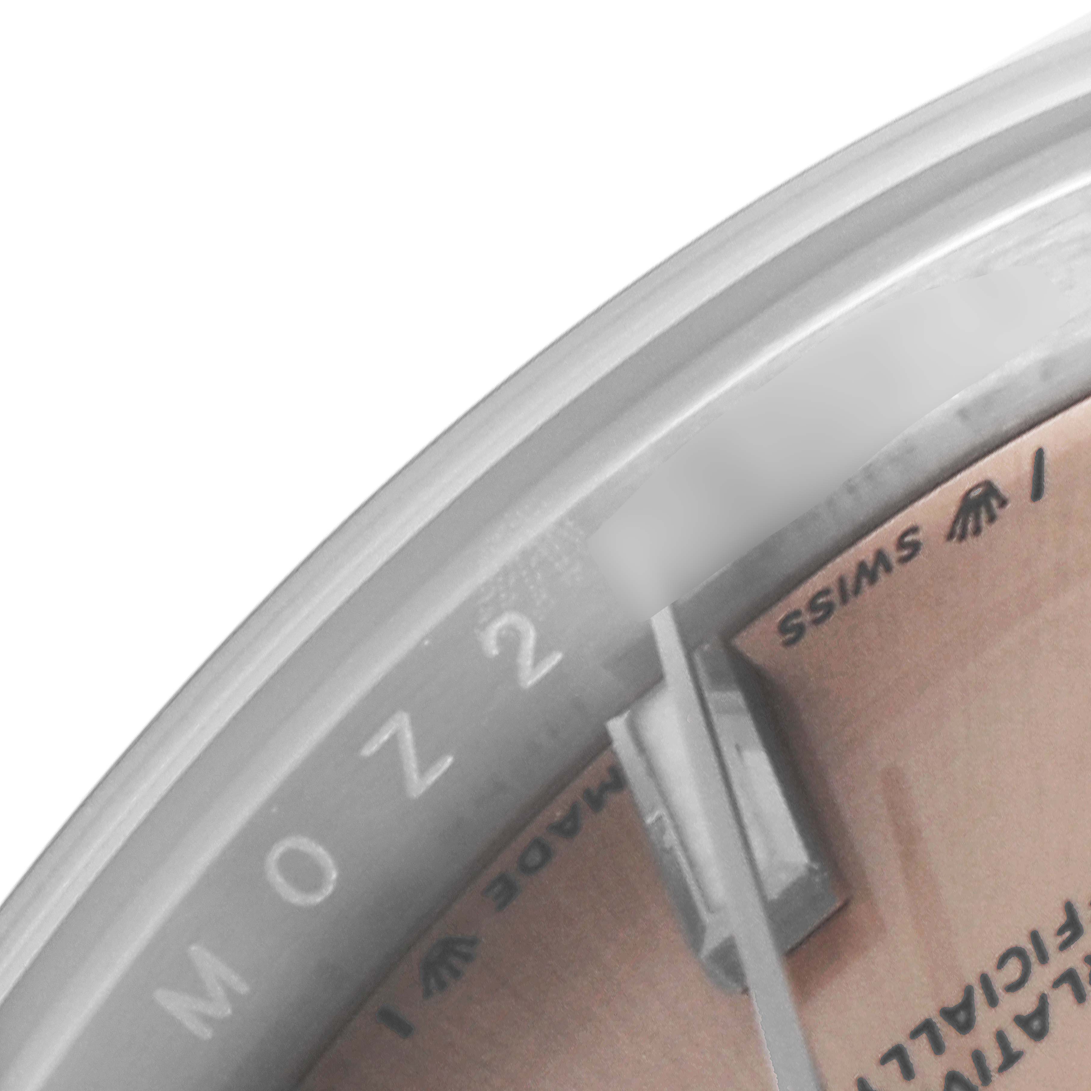 The image shows a close-up perspective of the dial and the inner bezel of the Rolex Oyster Perpetual 276200 Women
s Stainless Steel Pink Dial 276200 Women
s Stainless Steel Pink Dial watch.